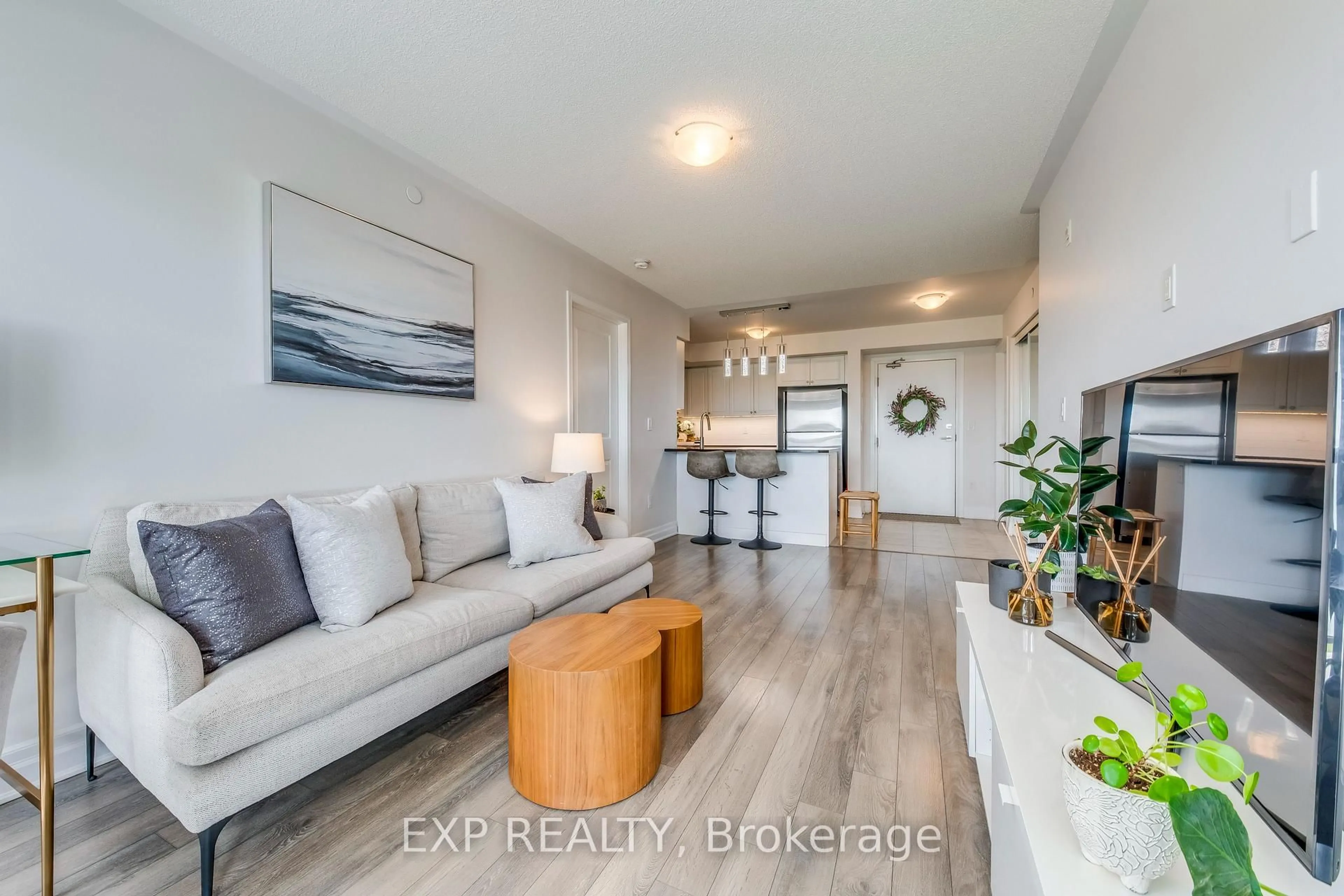 Living room with furniture, wood/laminate floor for 1005 Nadalin Hts #406, Milton Ontario L9T 8R4