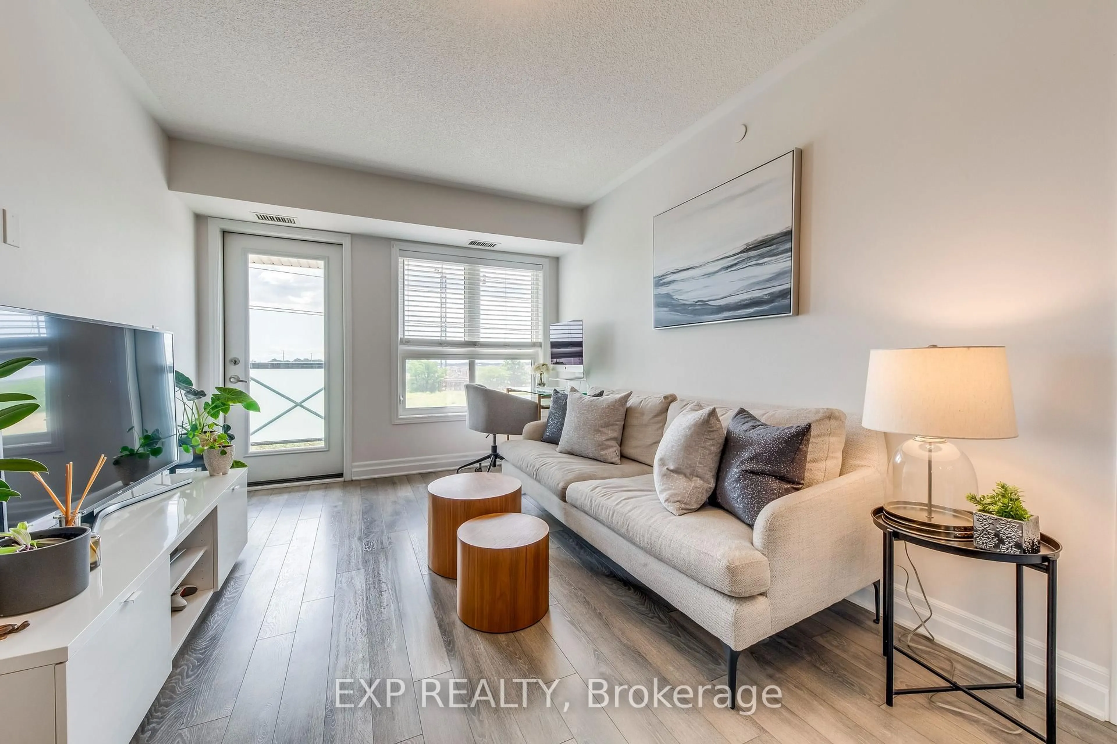 Living room with furniture, wood/laminate floor for 1005 Nadalin Hts #406, Milton Ontario L9T 8R4