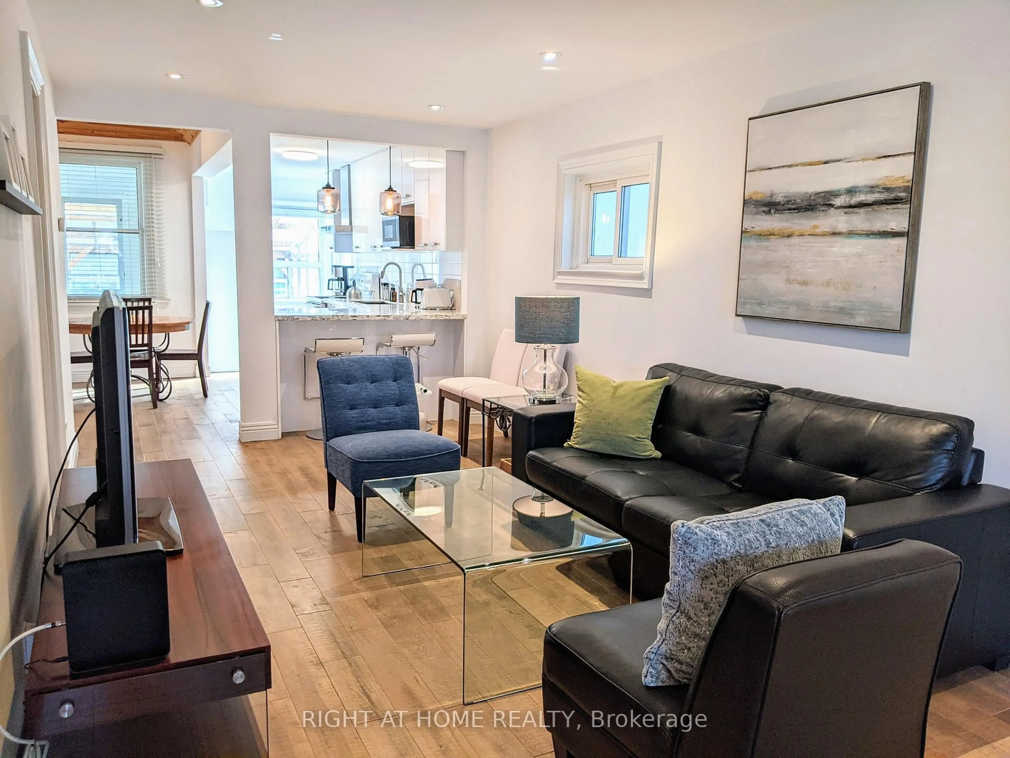 Living room with furniture, wood/laminate floor for 53 Sixteenth St, Toronto Ontario M8V 3J7