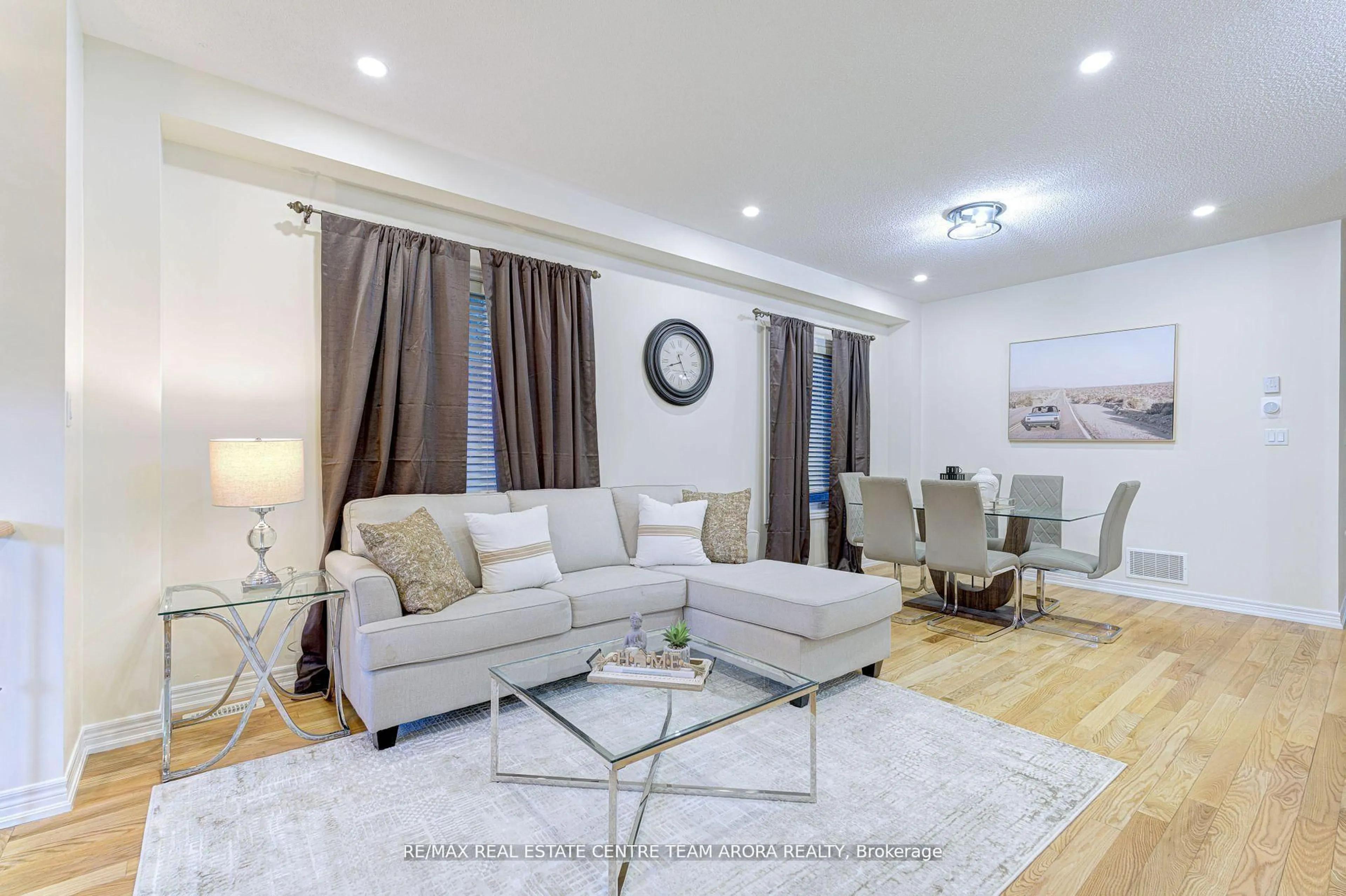 Living room with furniture, wood/laminate floor for 42 Arrowpoint Dr, Brampton Ontario L6Y 0Y8