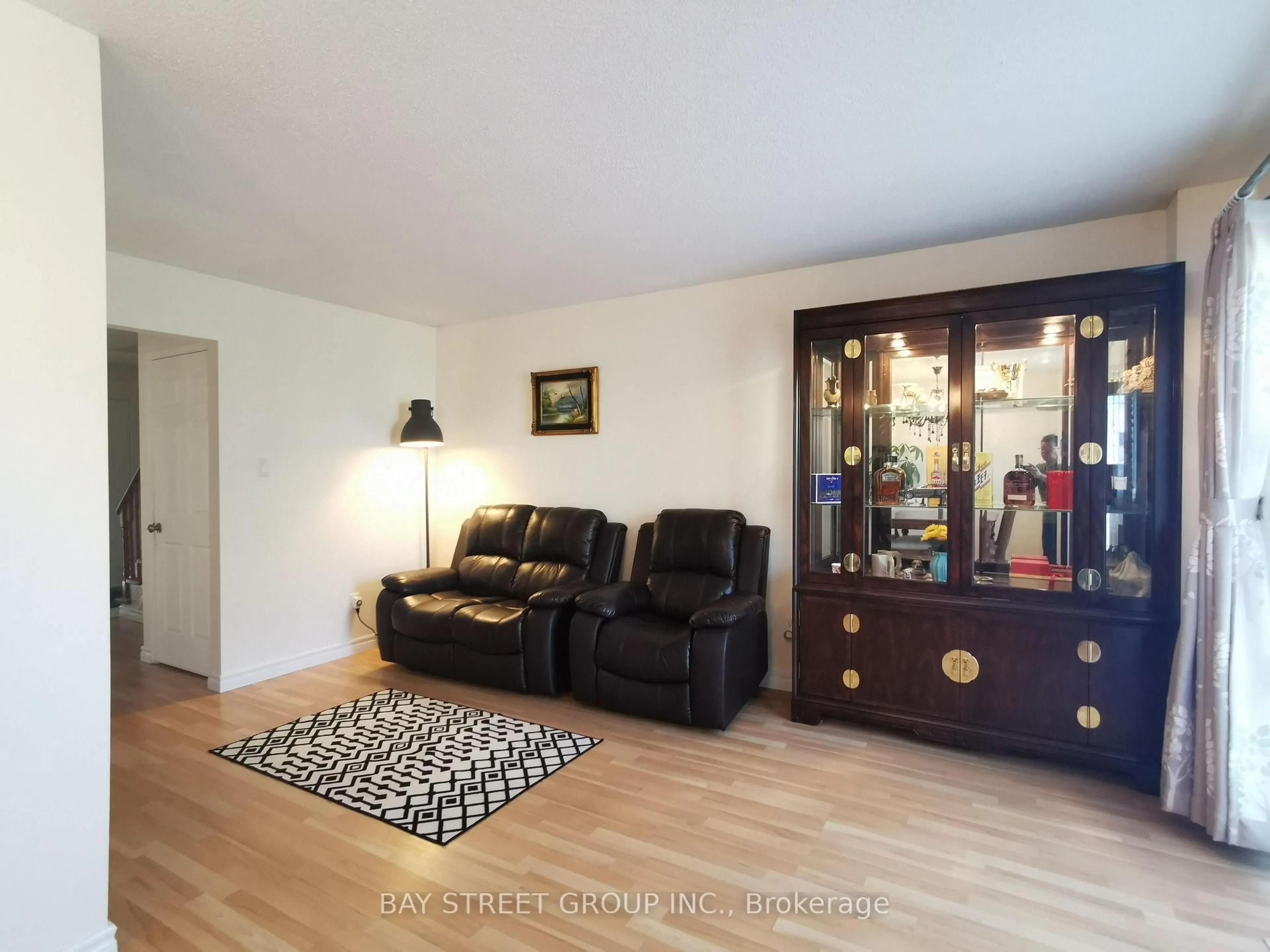 Living room with furniture, wood/laminate floor for 77 Toba Cres, Brampton Ontario L6Z 4R8