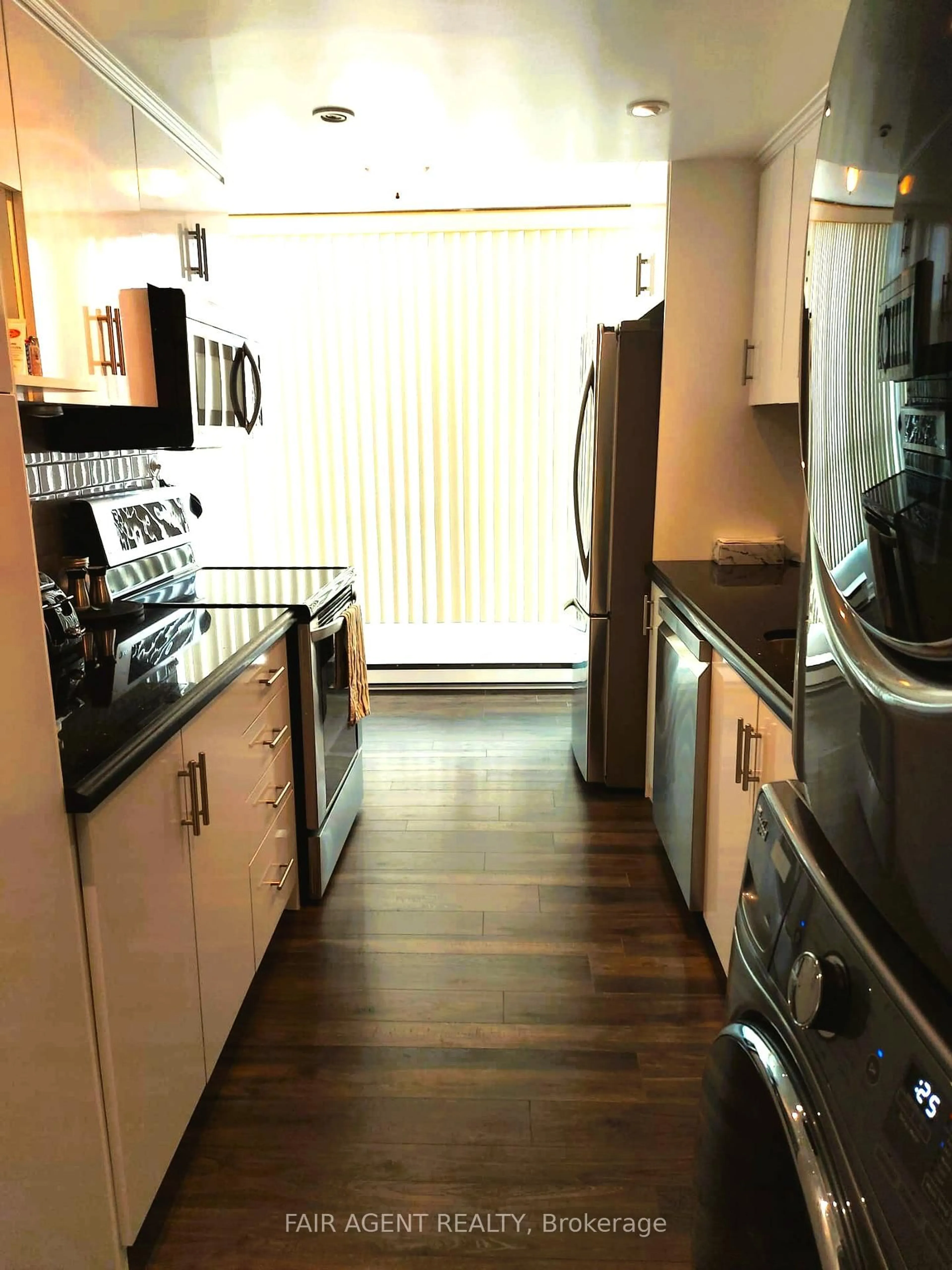 Kitchen with laundary machines, unknown for 3077 Weston Rd #409, Toronto Ontario M9M 3A1