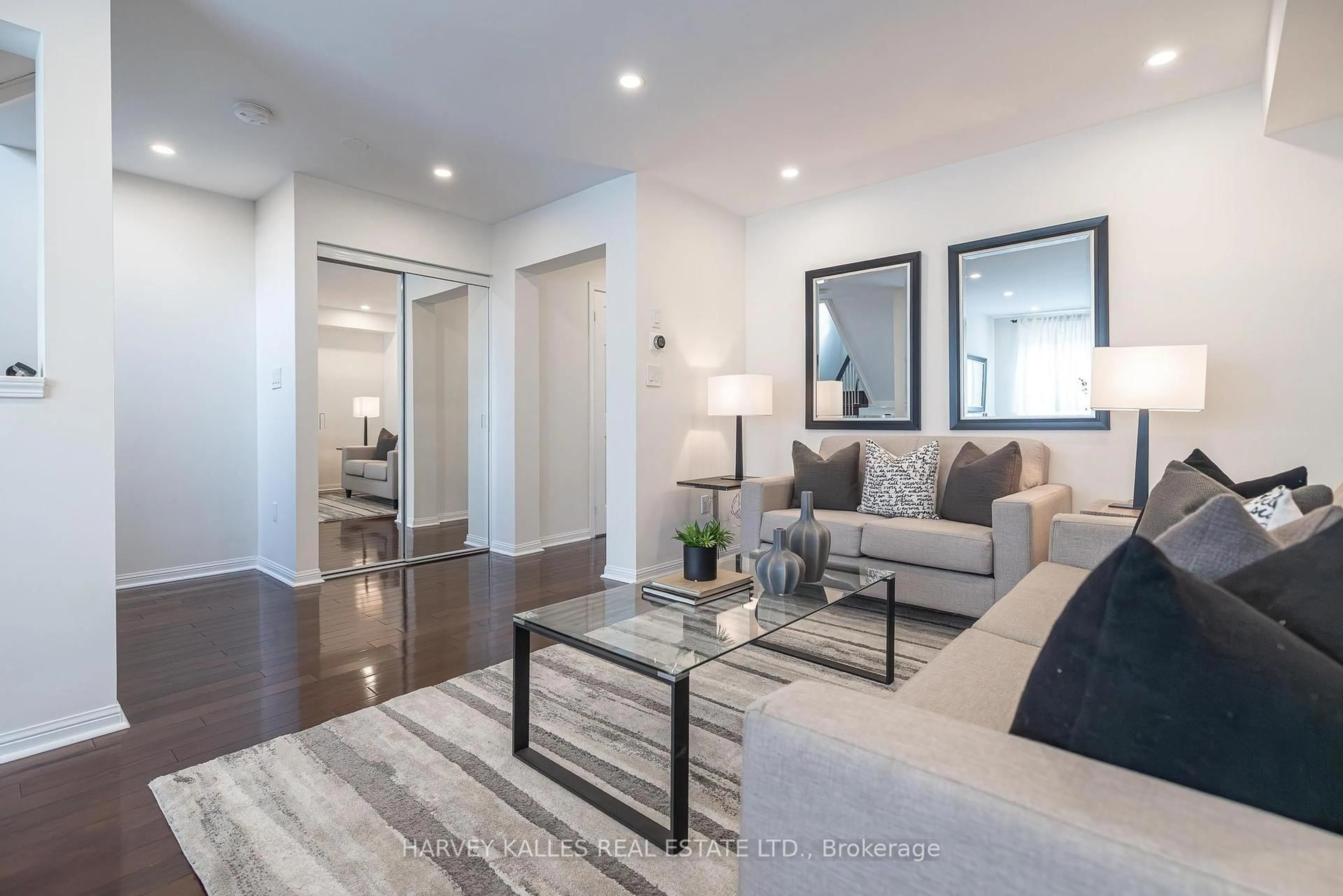 Living room with furniture, wood/laminate floor for 5980 Whitehorn Ave #30, Mississauga Ontario L5V 2Y2