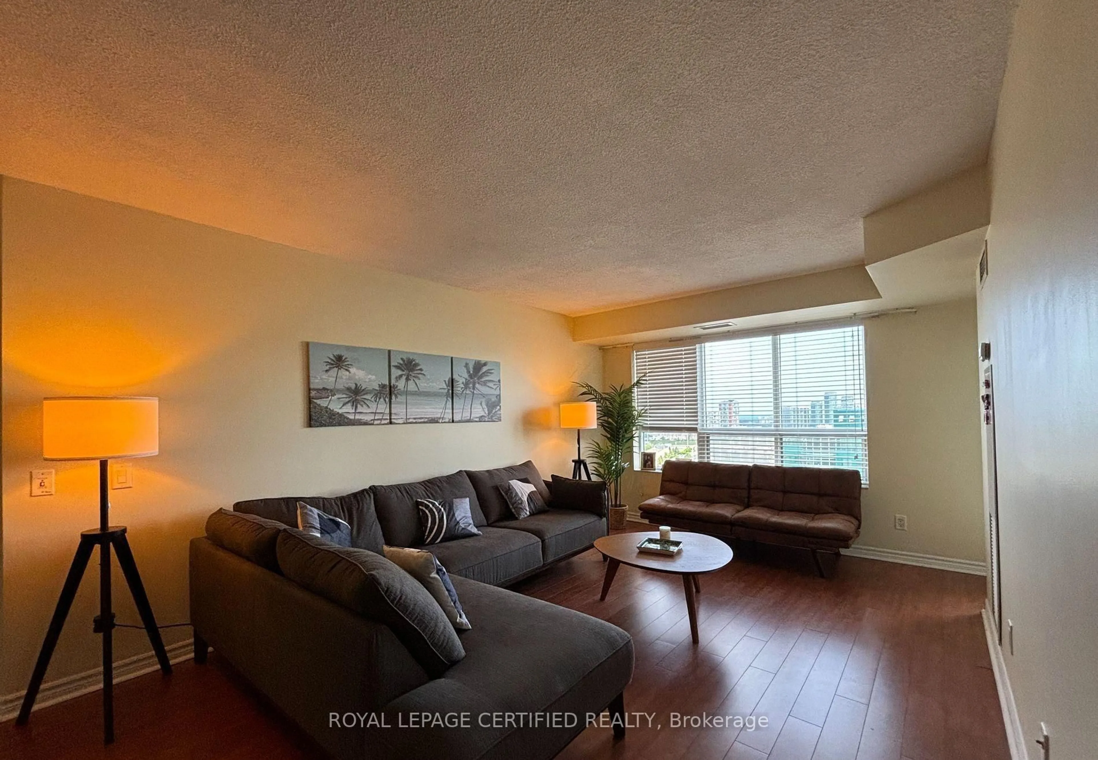 Living room with furniture, wood/laminate floor for 25 Kingsbridge Garden Circ #1526, Mississauga Ontario L5R 3Z5