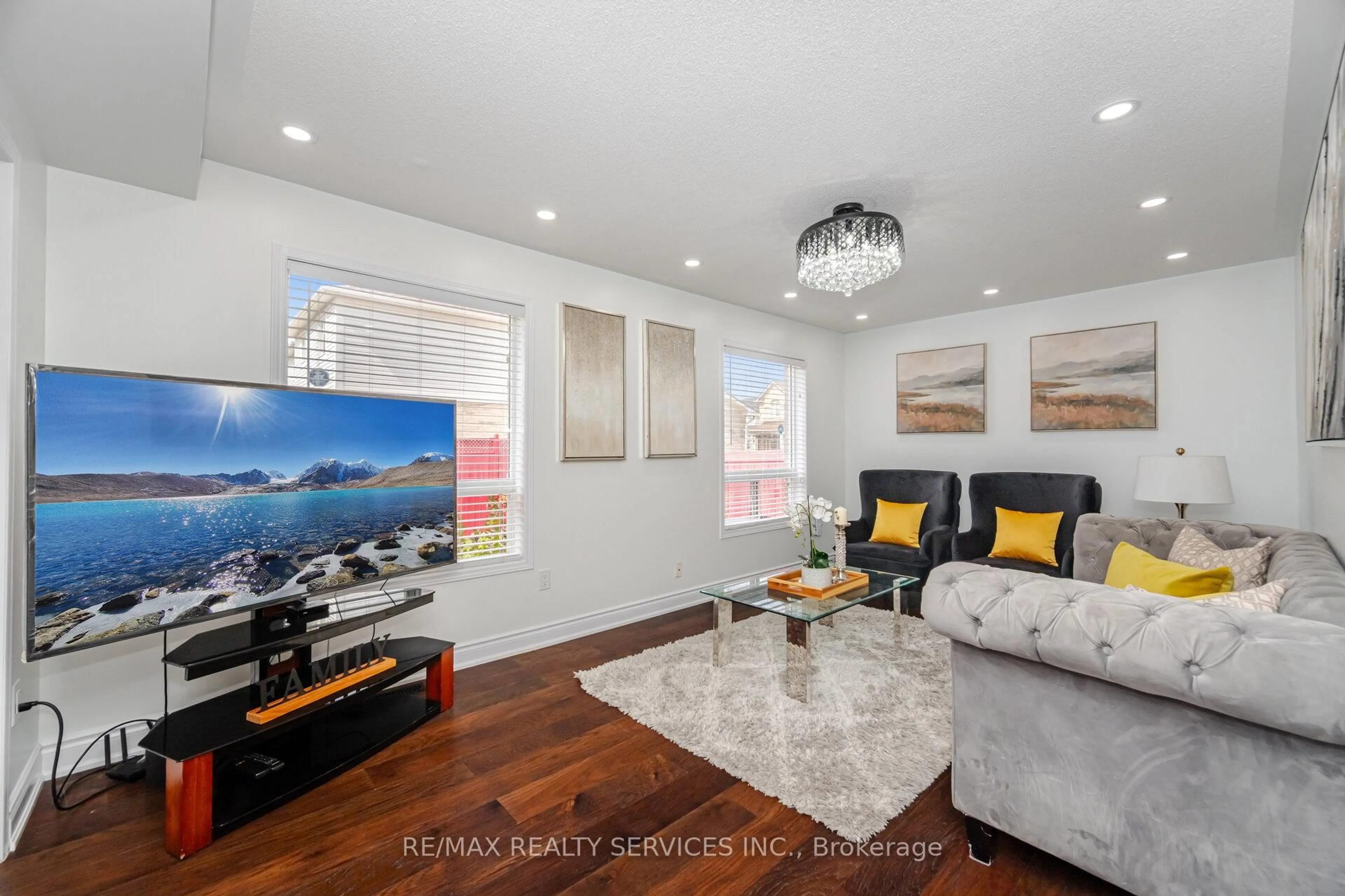 Living room with furniture, wood/laminate floor for 12 Woodvalley Dr, Brampton Ontario L7A 1Z5