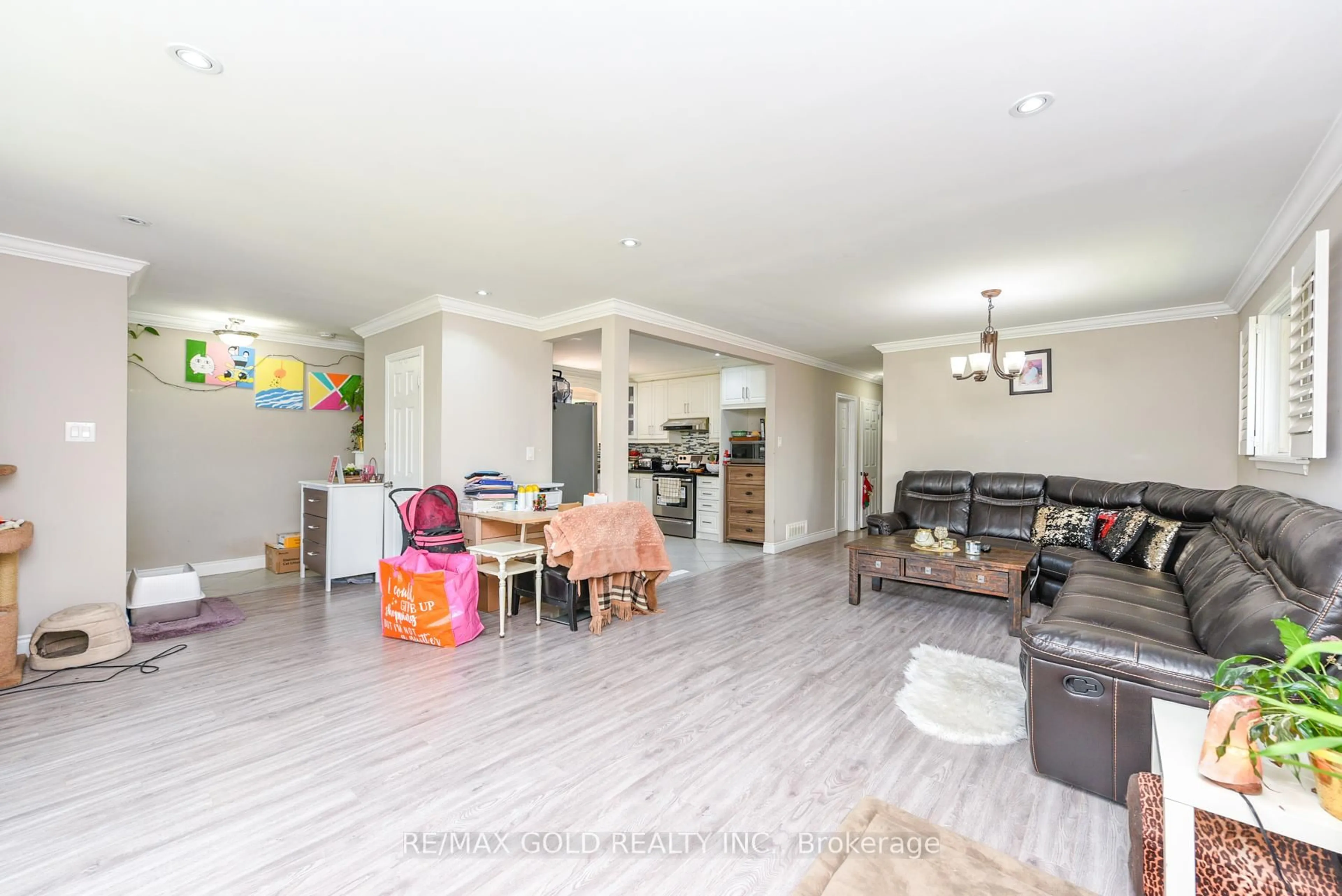 Living room with furniture, wood/laminate floor for 11 Dudley Pl, Brampton Ontario L6T 3C2