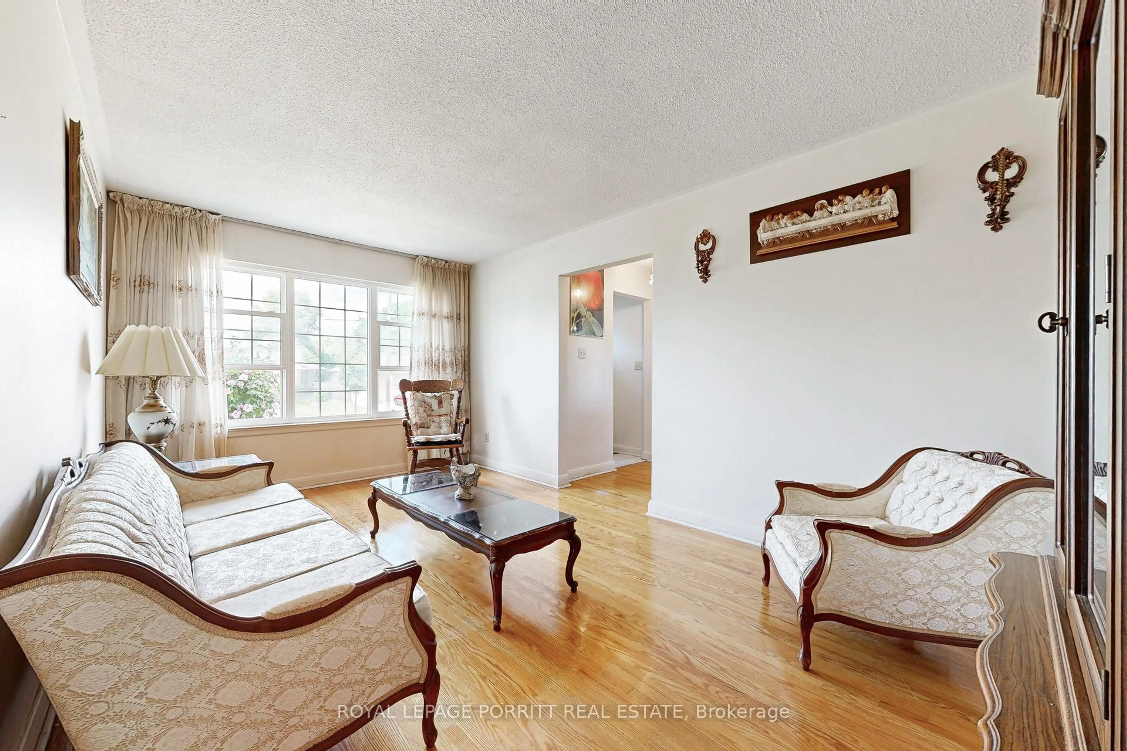 Living room with furniture, wood/laminate floor for 27 Hinton Rd, Toronto Ontario M9W 2V4