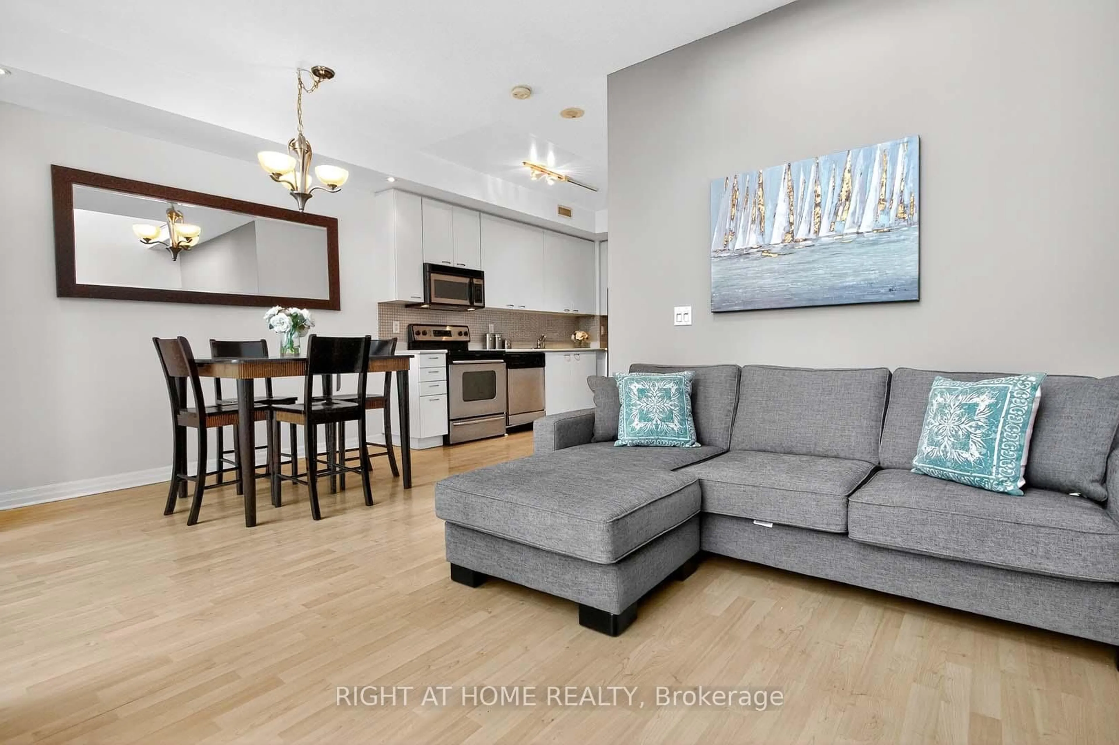 Living room with furniture, wood/laminate floor for 220 Burnhamthorpe Rd #717, Mississauga Ontario L5B 4N4