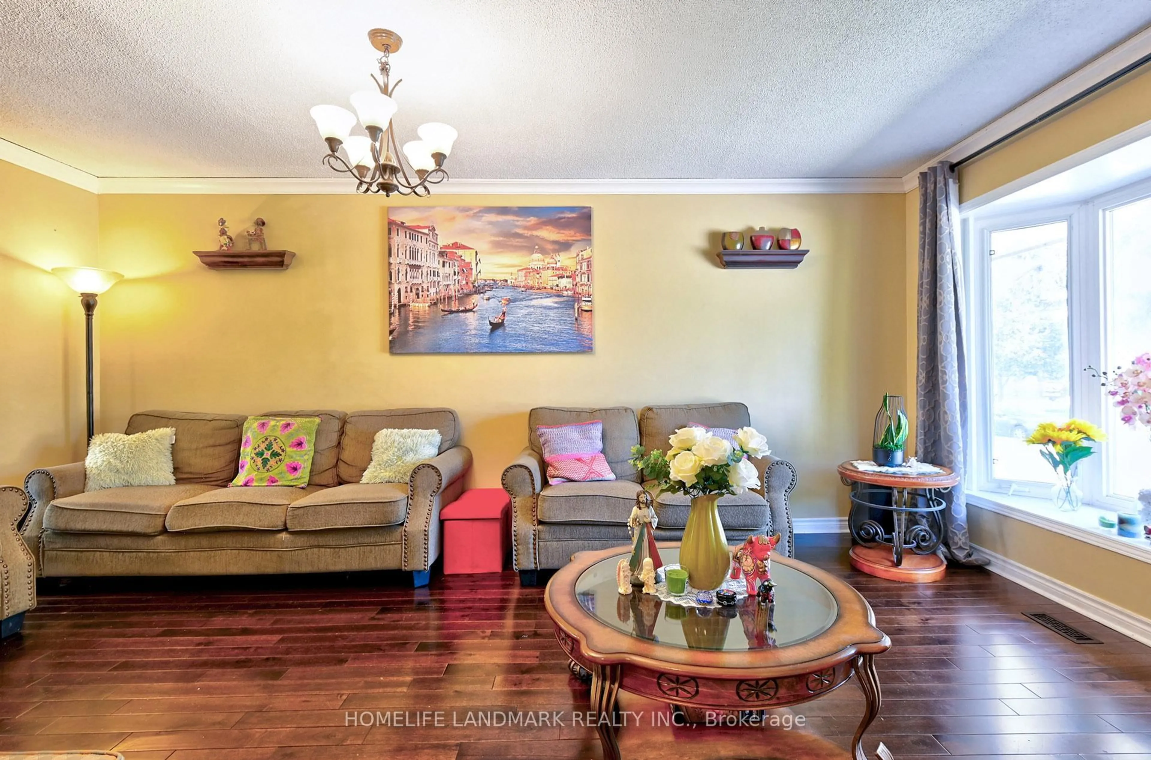 Living room with furniture, wood/laminate floor for 67 Crawford Dr, Brampton Ontario L6V 2C6