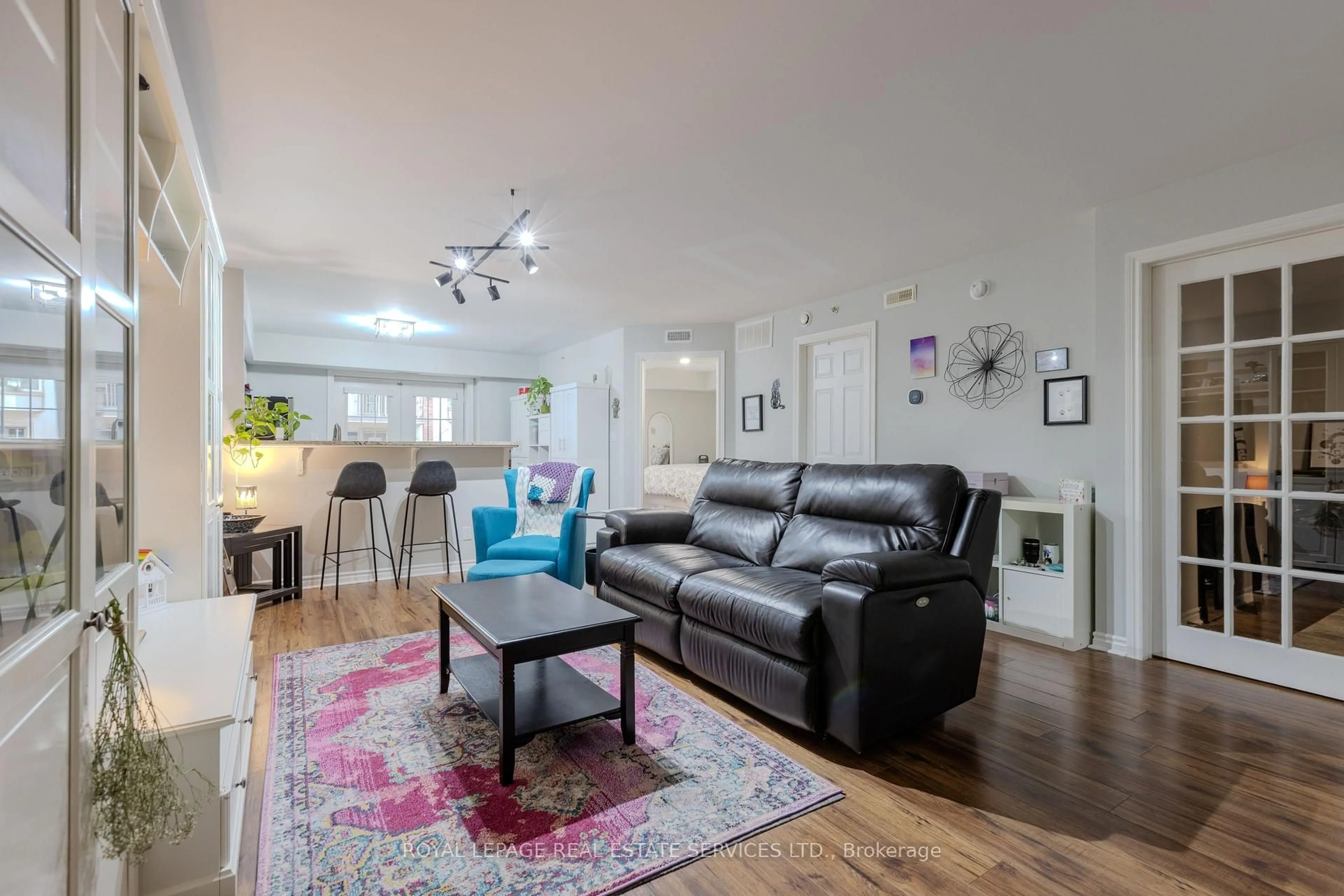Living room with furniture, wood/laminate floor for 4013 Kilmer Dr #107, Burlington Ontario L7M 4M3