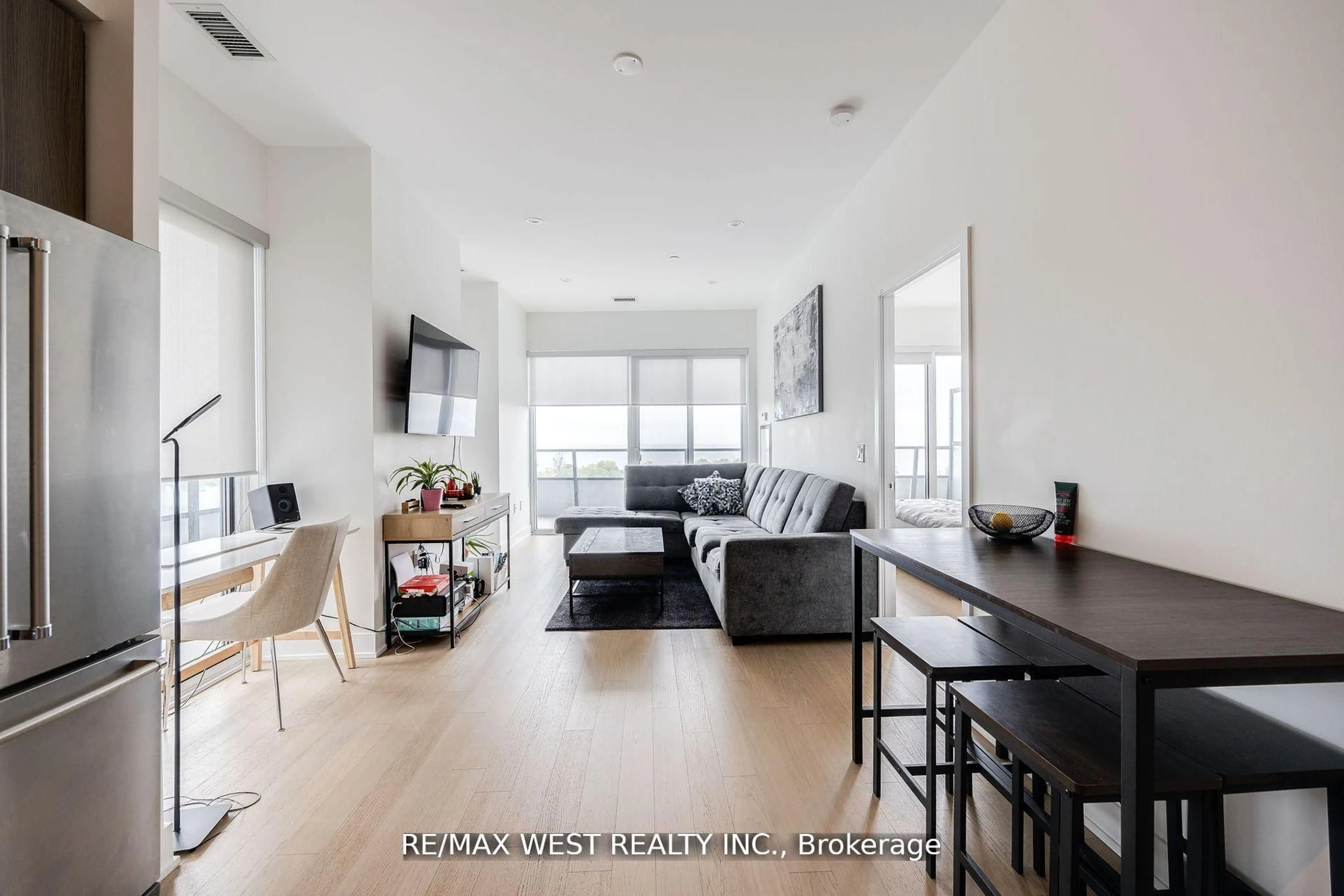 Living room with furniture, wood/laminate floor for 20 Shore Breeze Dr #702, Toronto Ontario M8V 0C7