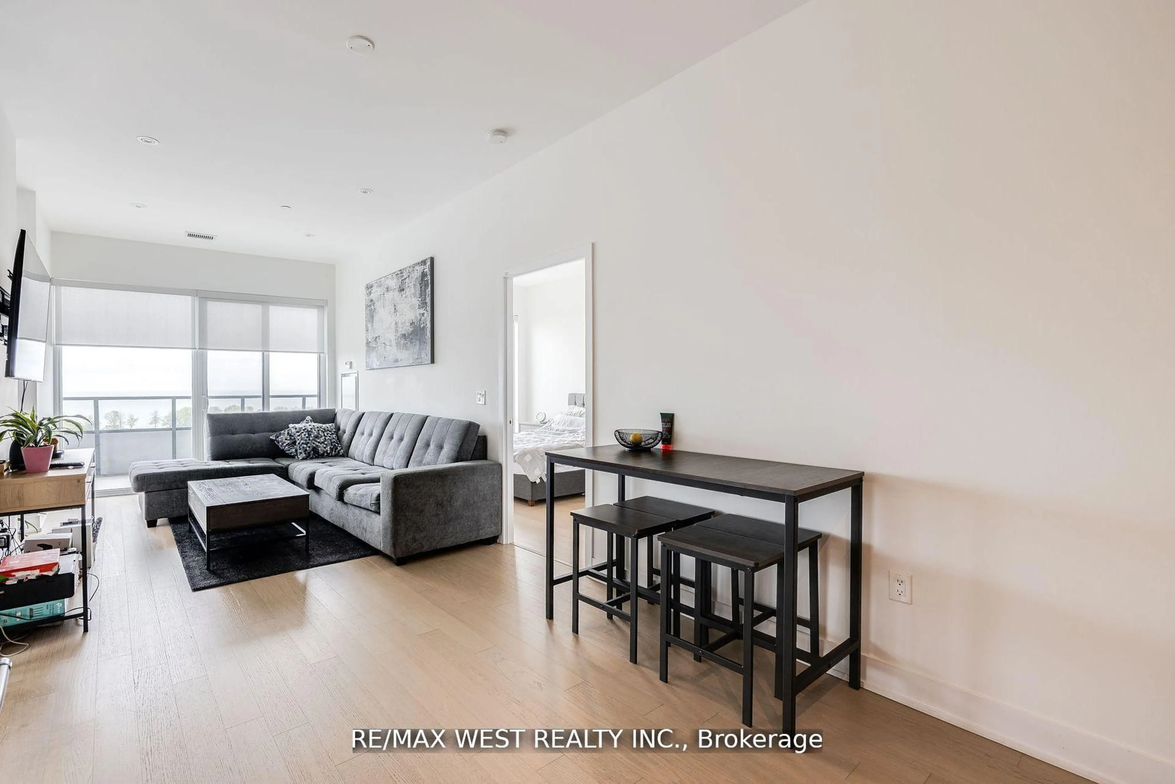 Living room with furniture, wood/laminate floor for 20 Shore Breeze Dr #702, Toronto Ontario M8V 0C7