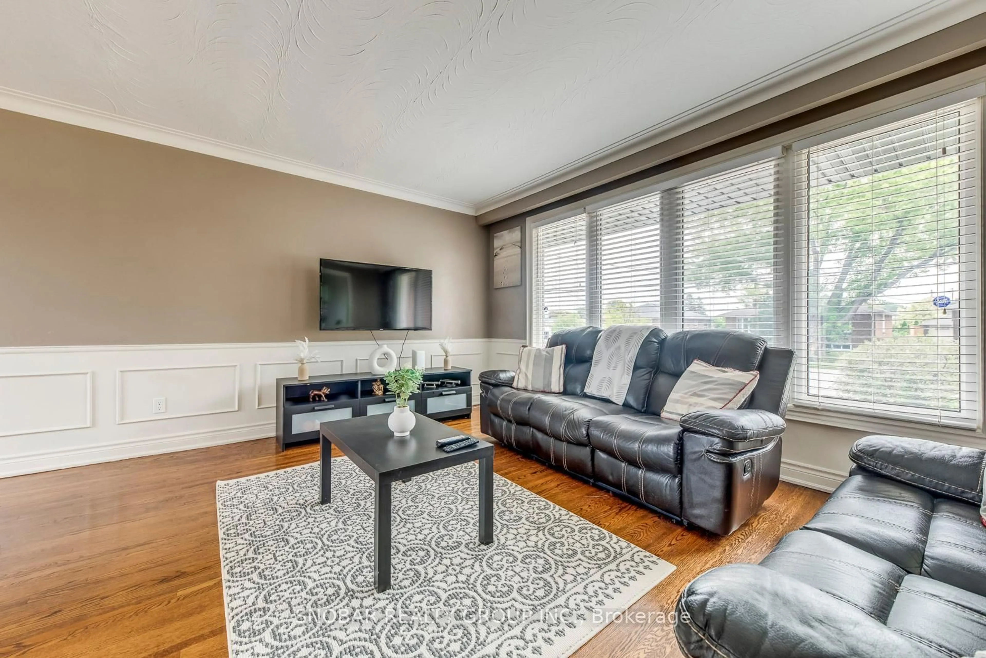 Living room with furniture, wood/laminate floor for 44 Arkley Cres, Toronto Ontario M9R 3S3
