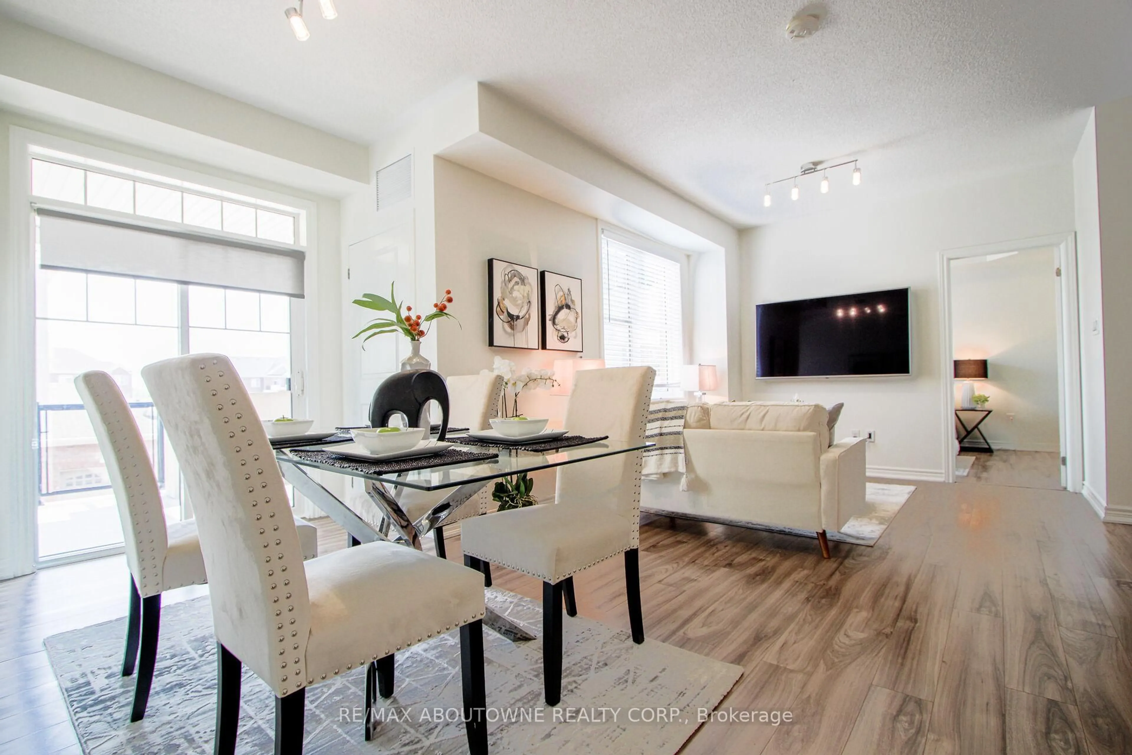 Living room with furniture, wood/laminate floor for 2339 Sawgrass Dr #206, Oakville Ontario L6H 0L1