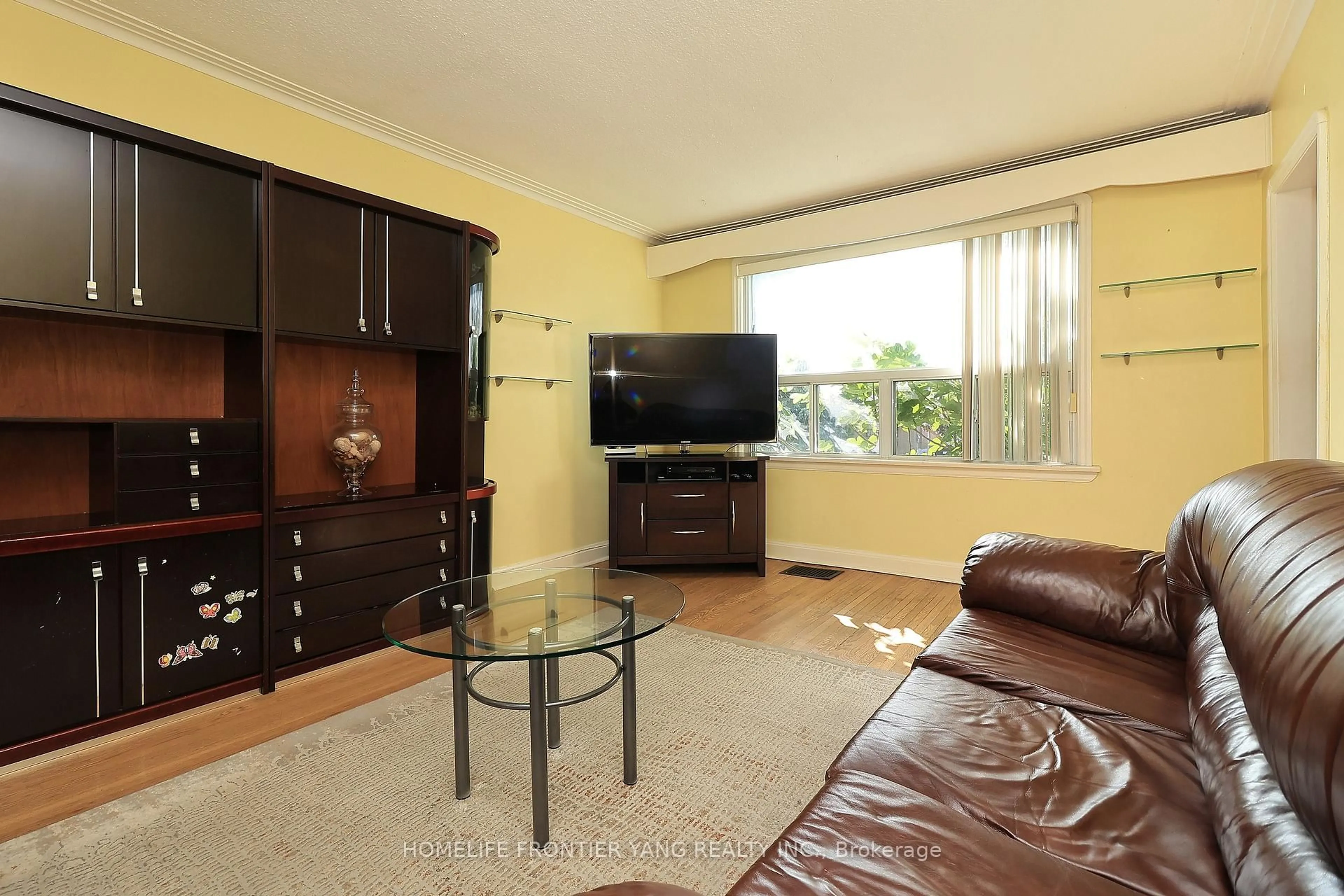 Living room with furniture, wood/laminate floor for 66 Cartwright Ave, Toronto Ontario M6A 1T9