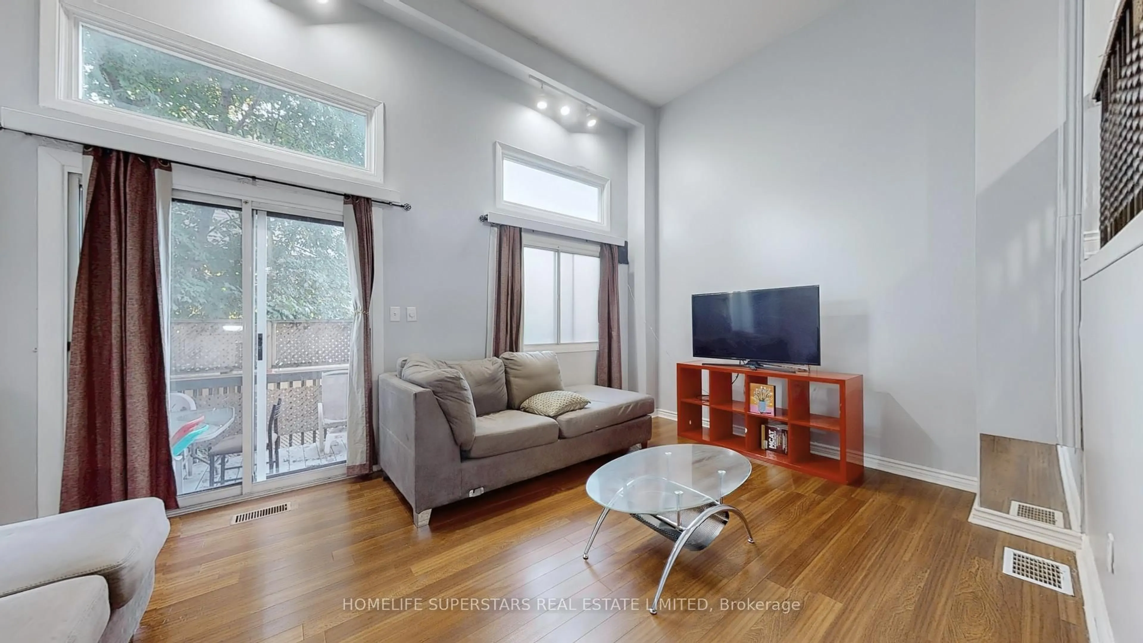 Living room with furniture, wood/laminate floor for 76 Collins Cres, Brampton Ontario L6V 3N1