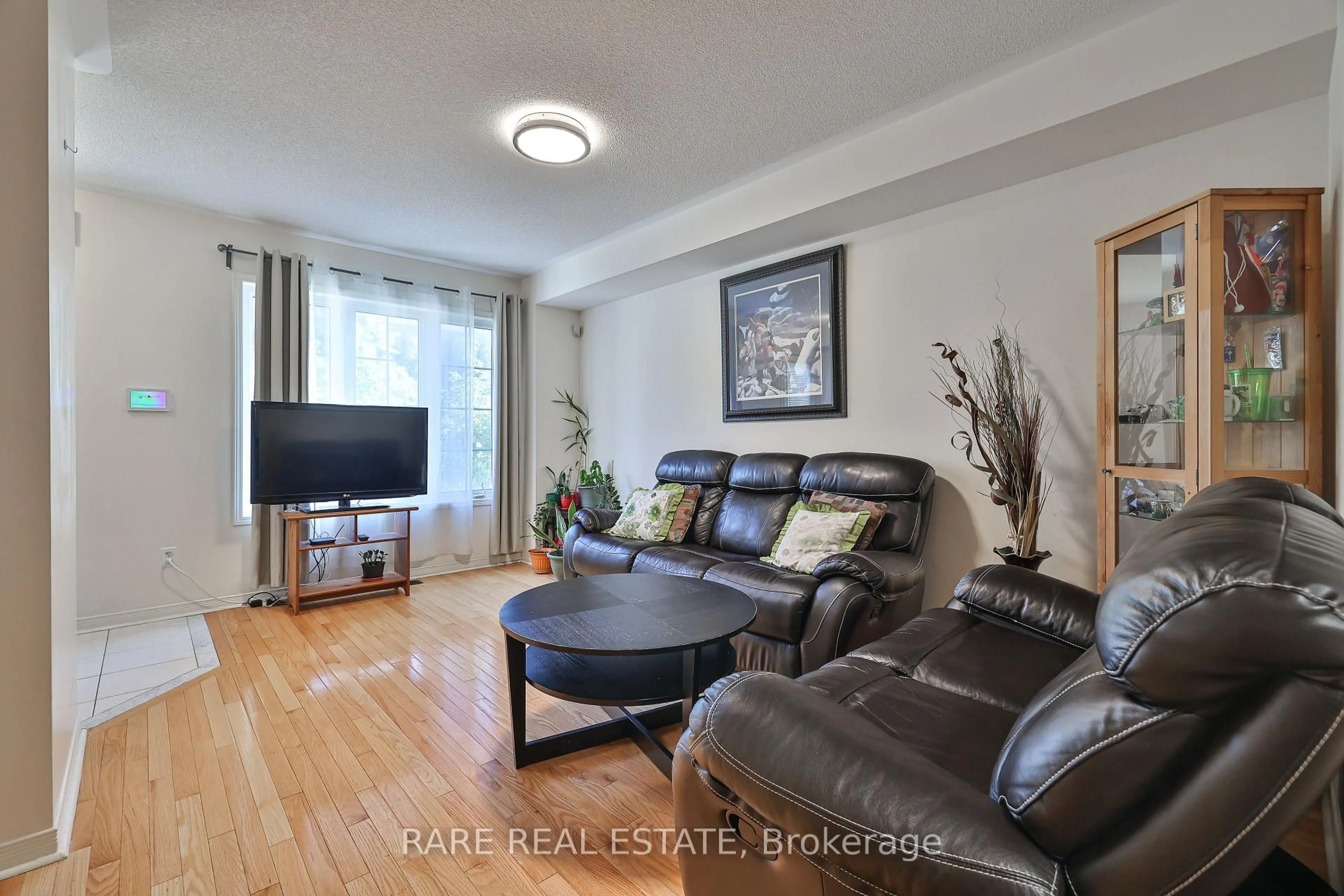 Living room with furniture, wood/laminate floor for 34 Judy Sgro Ave, Toronto Ontario M3L 0E3