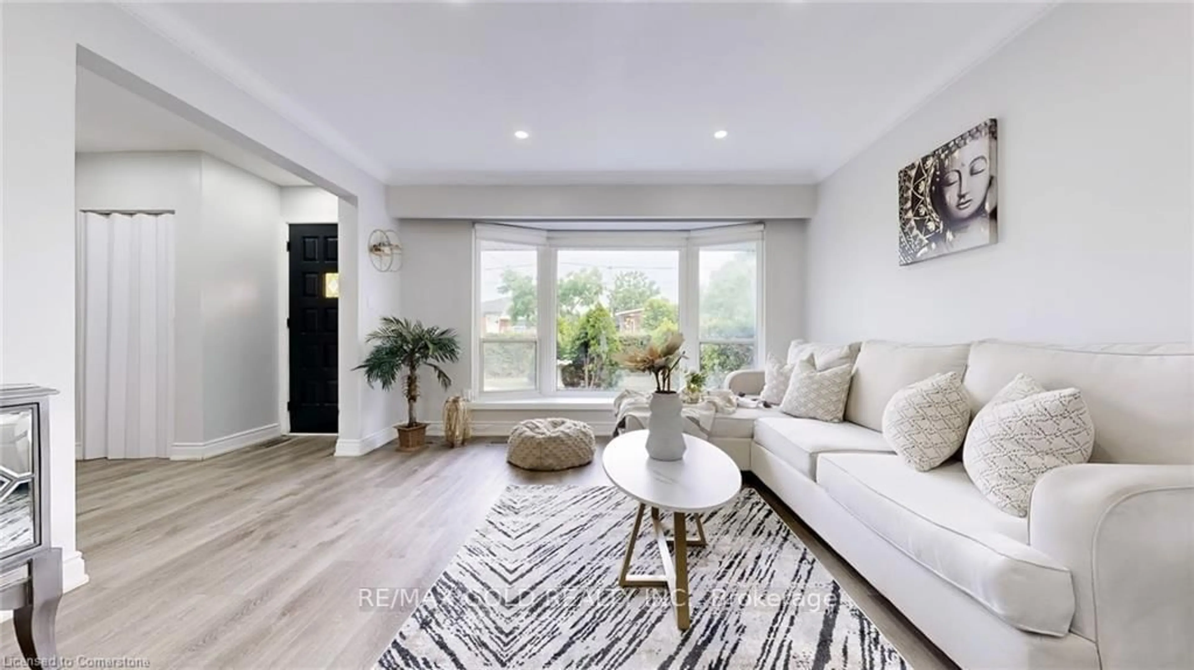 Living room with furniture, wood/laminate floor for 28 Navenby Cres, Toronto Ontario M9L 1B2
