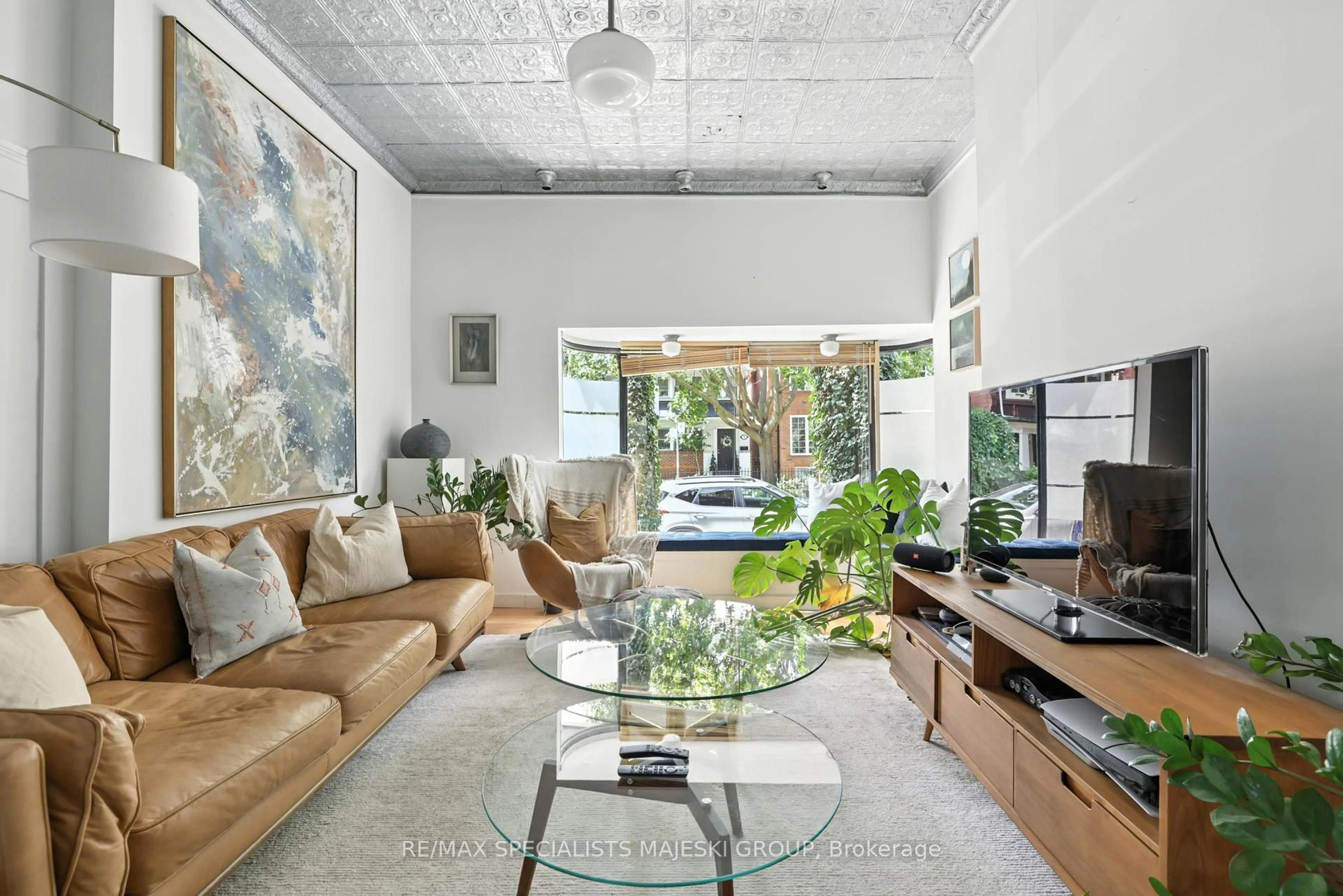 Living room with furniture, cement floor for 69 Elm Grove Ave, Toronto Ontario M6K 2J2