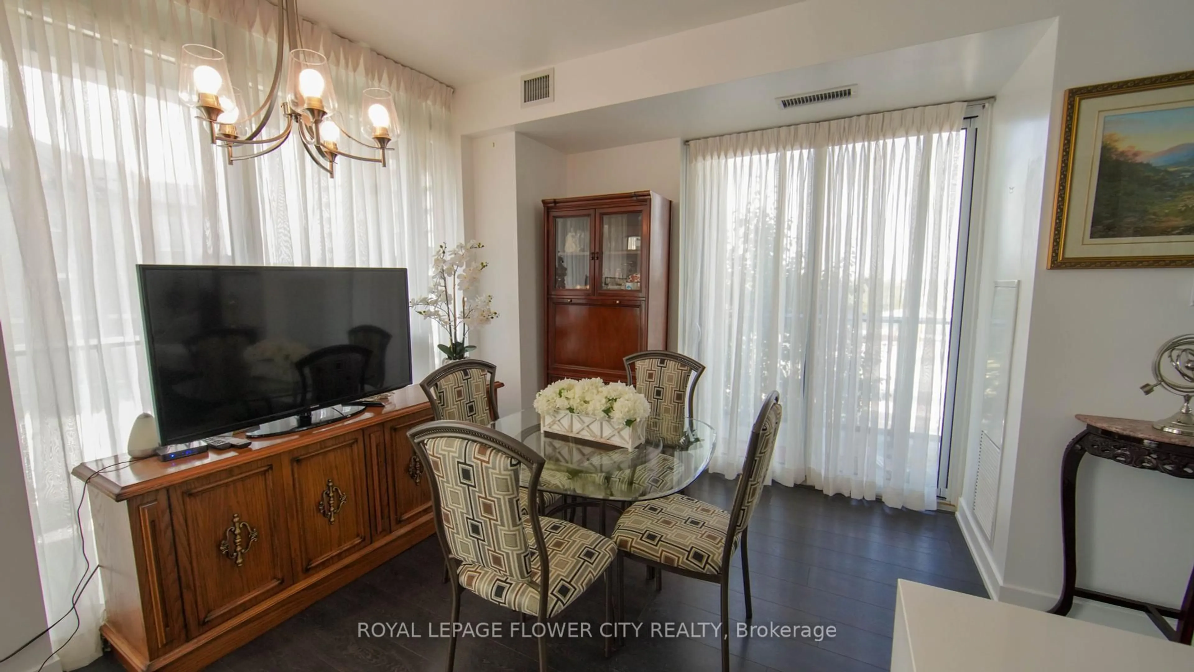 Living room with furniture, wood/laminate floor for 180 Veterans Dr #203, Brampton Ontario L7A 5G7