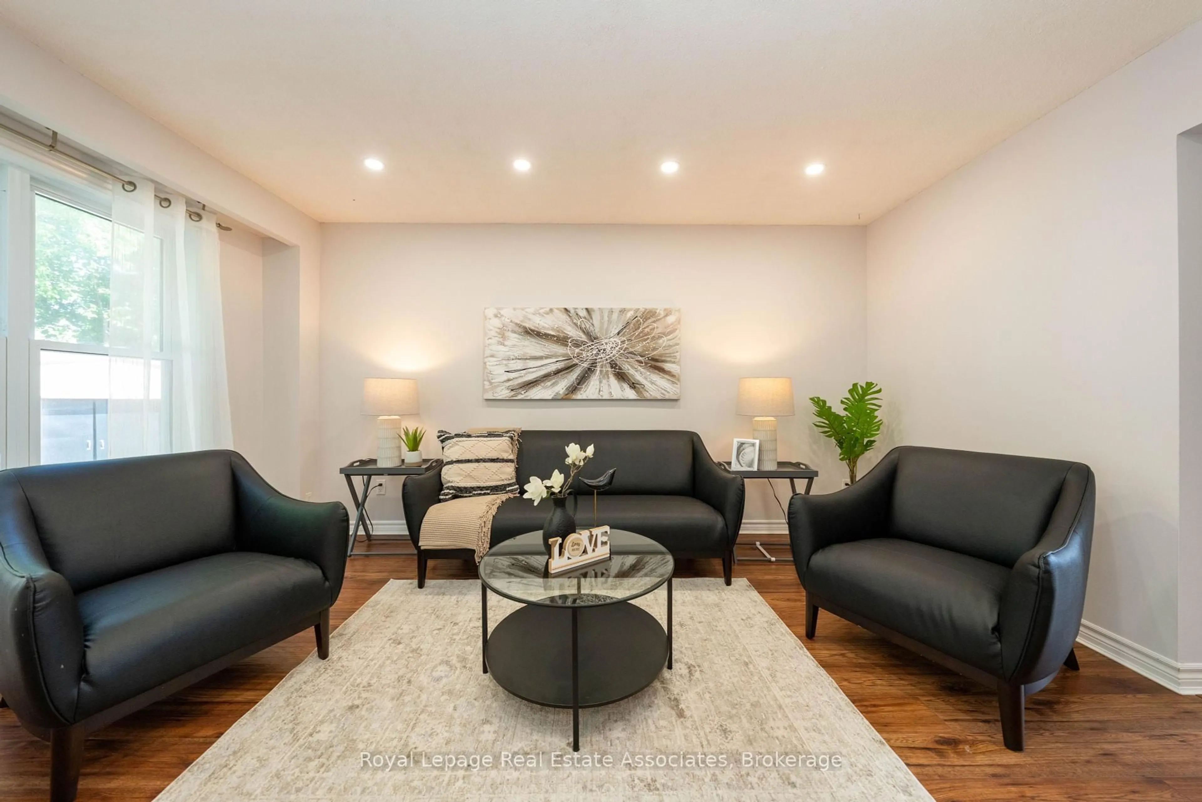 Living room with furniture, wood/laminate floor for 19 Burbank Cres, Orangeville Ontario L9W 3E6