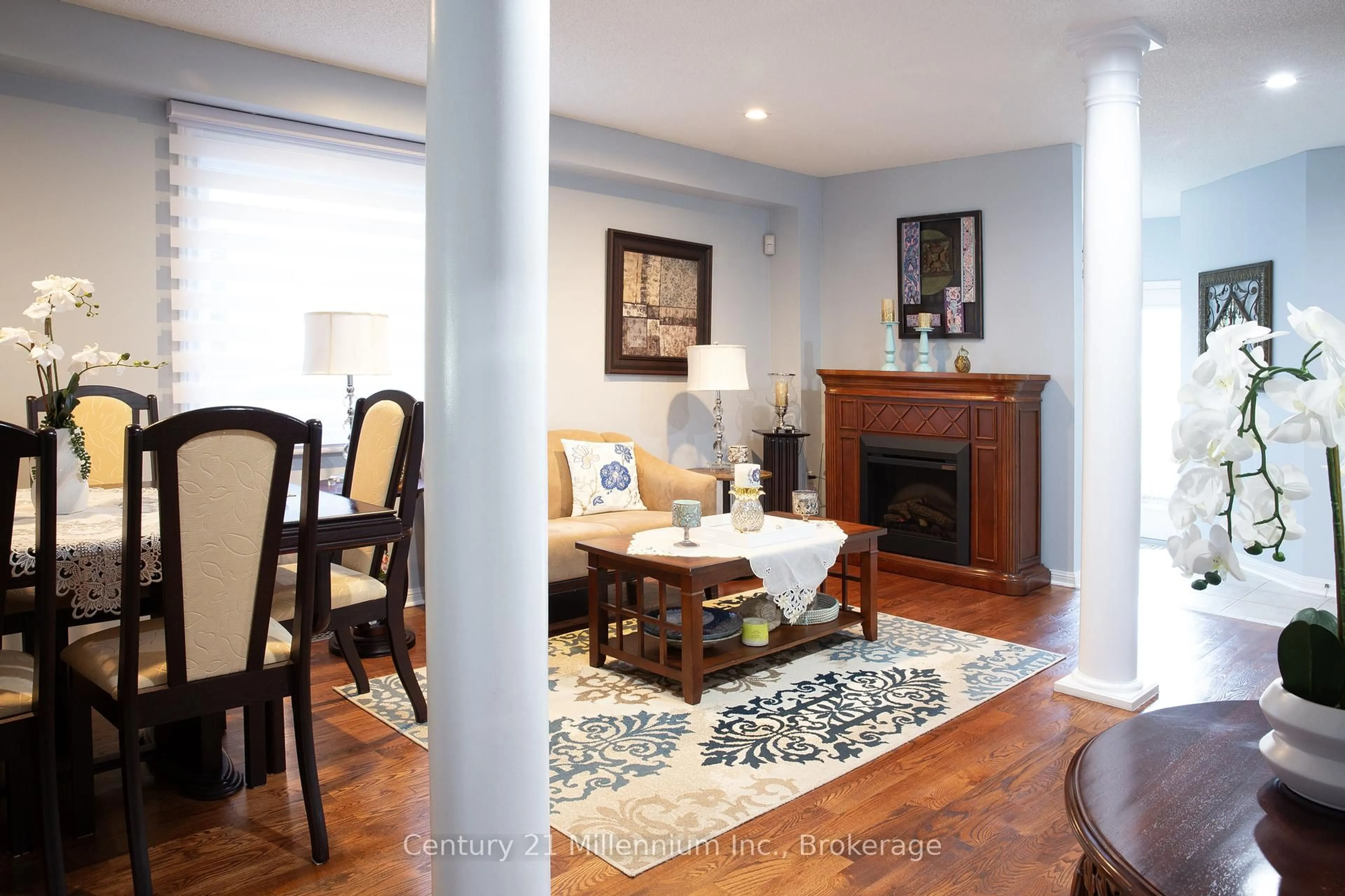 Living room with furniture, wood/laminate floor for 84 Weather Vane Lane, Brampton Ontario L6X 4R4