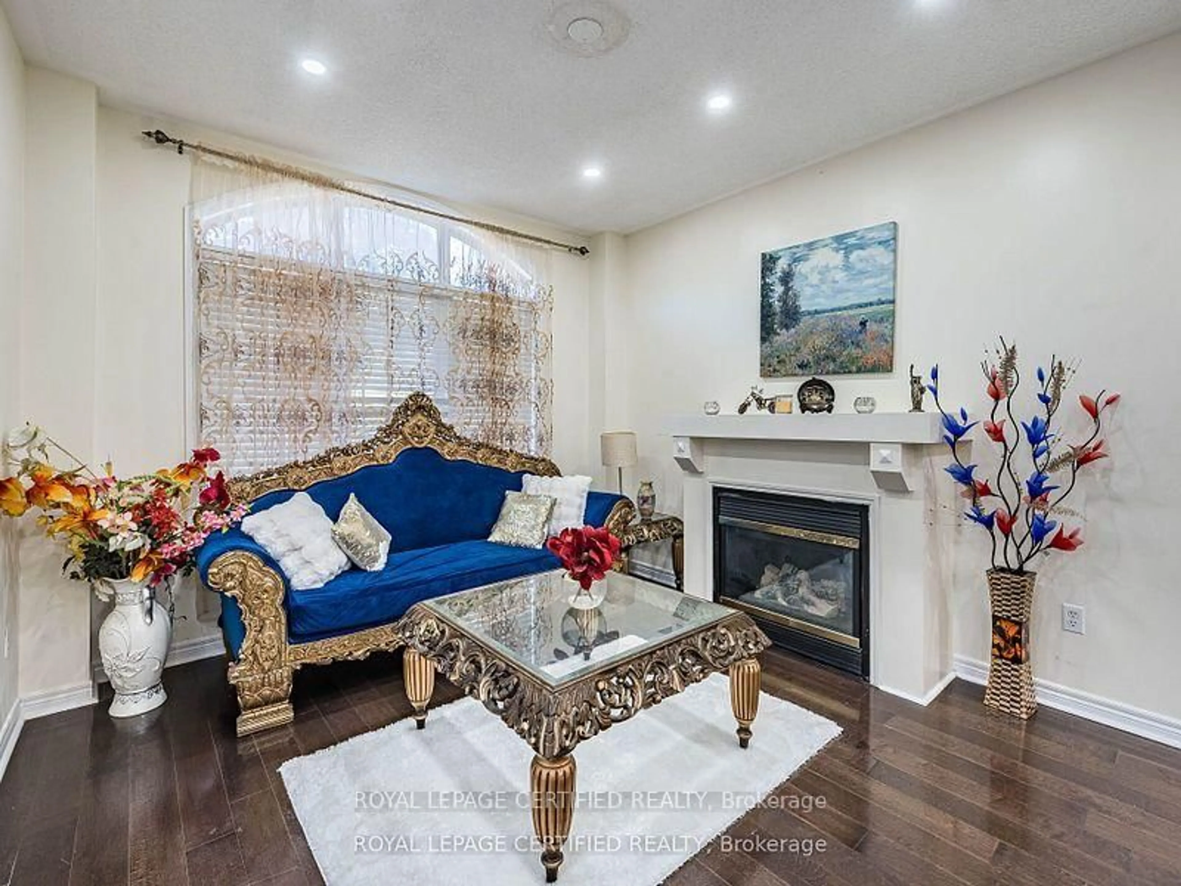 Living room with furniture, wood/laminate floor for 5 Treeline Blvd, Brampton Ontario L6P 1C4