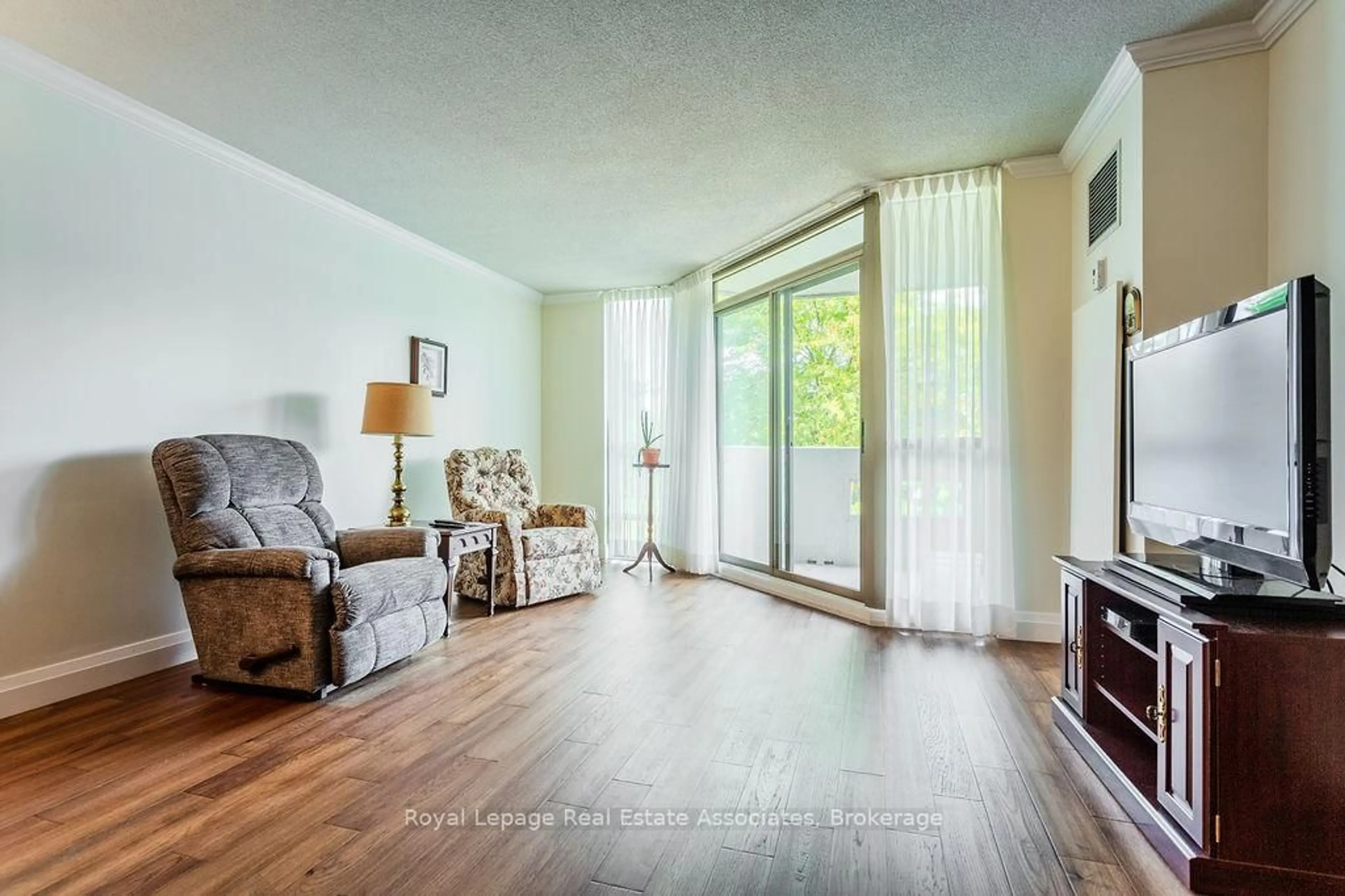 Living room with furniture, wood/laminate floor for 5070 Pinedale Ave #203, Burlington Ontario L7L 5V6