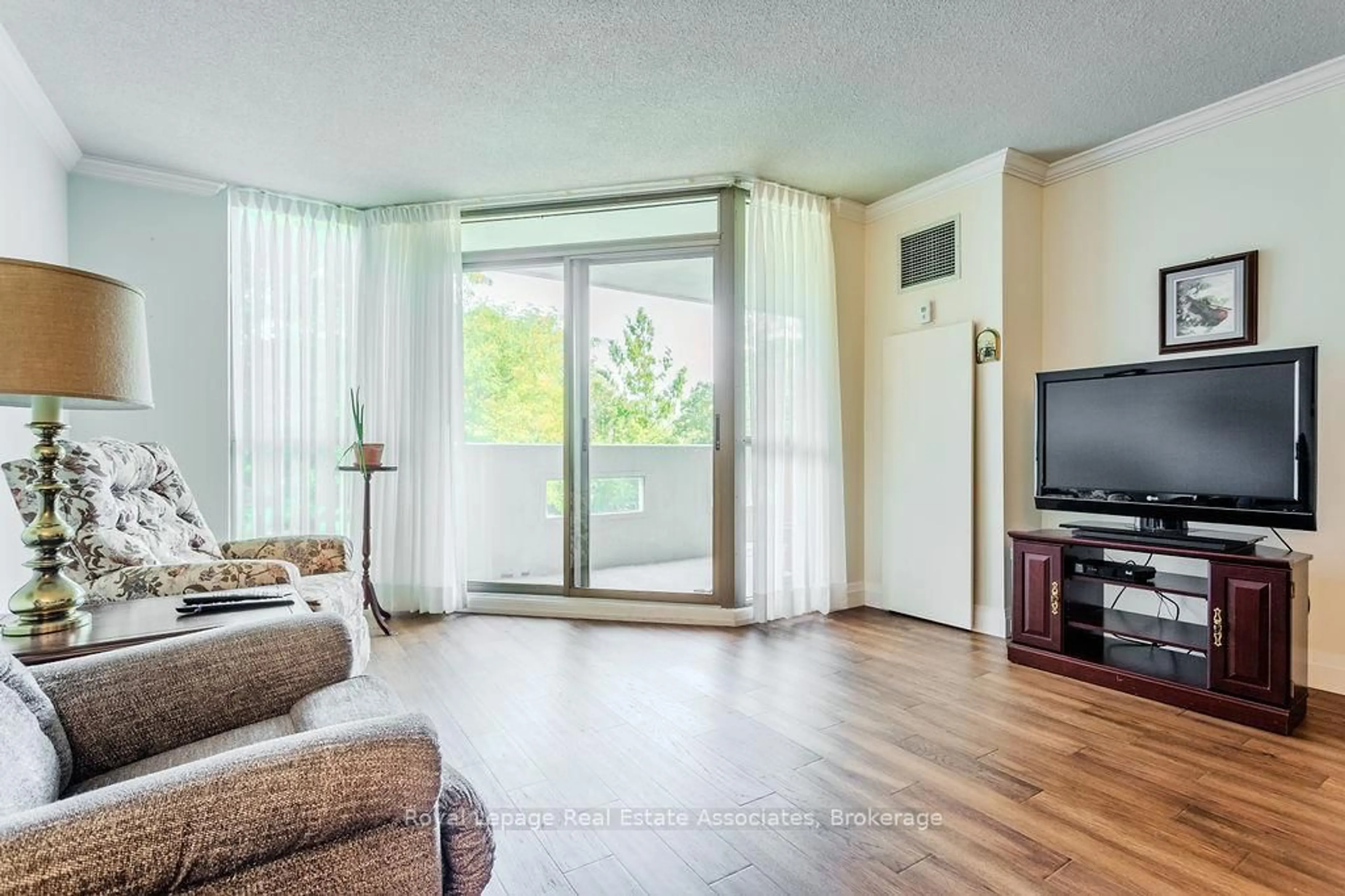 Living room with furniture, wood/laminate floor for 5070 Pinedale Ave #203, Burlington Ontario L7L 5V6