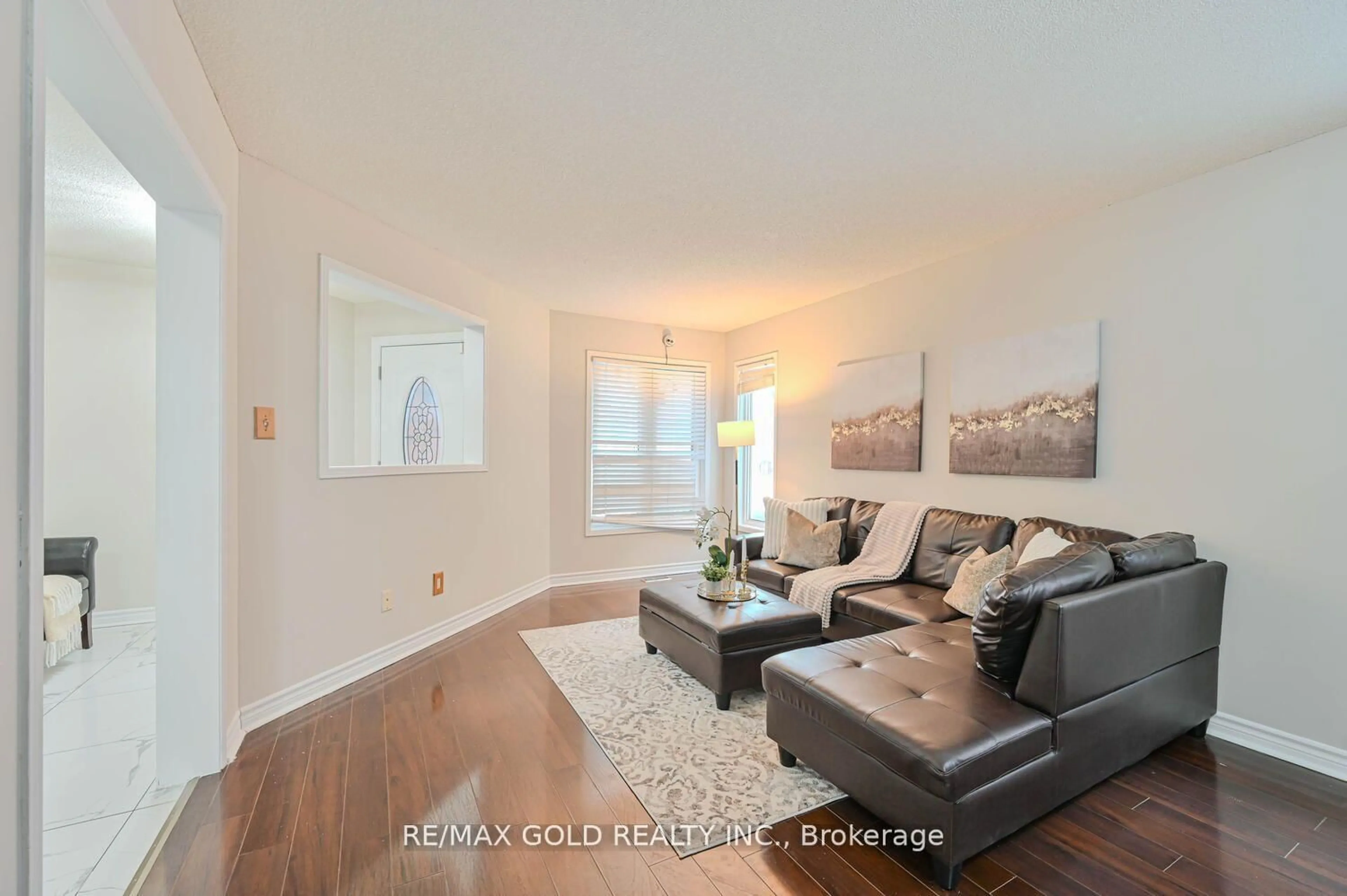 Living room with furniture, wood/laminate floor for 27 Buttercup Lane, Brampton Ontario L6R 1M9