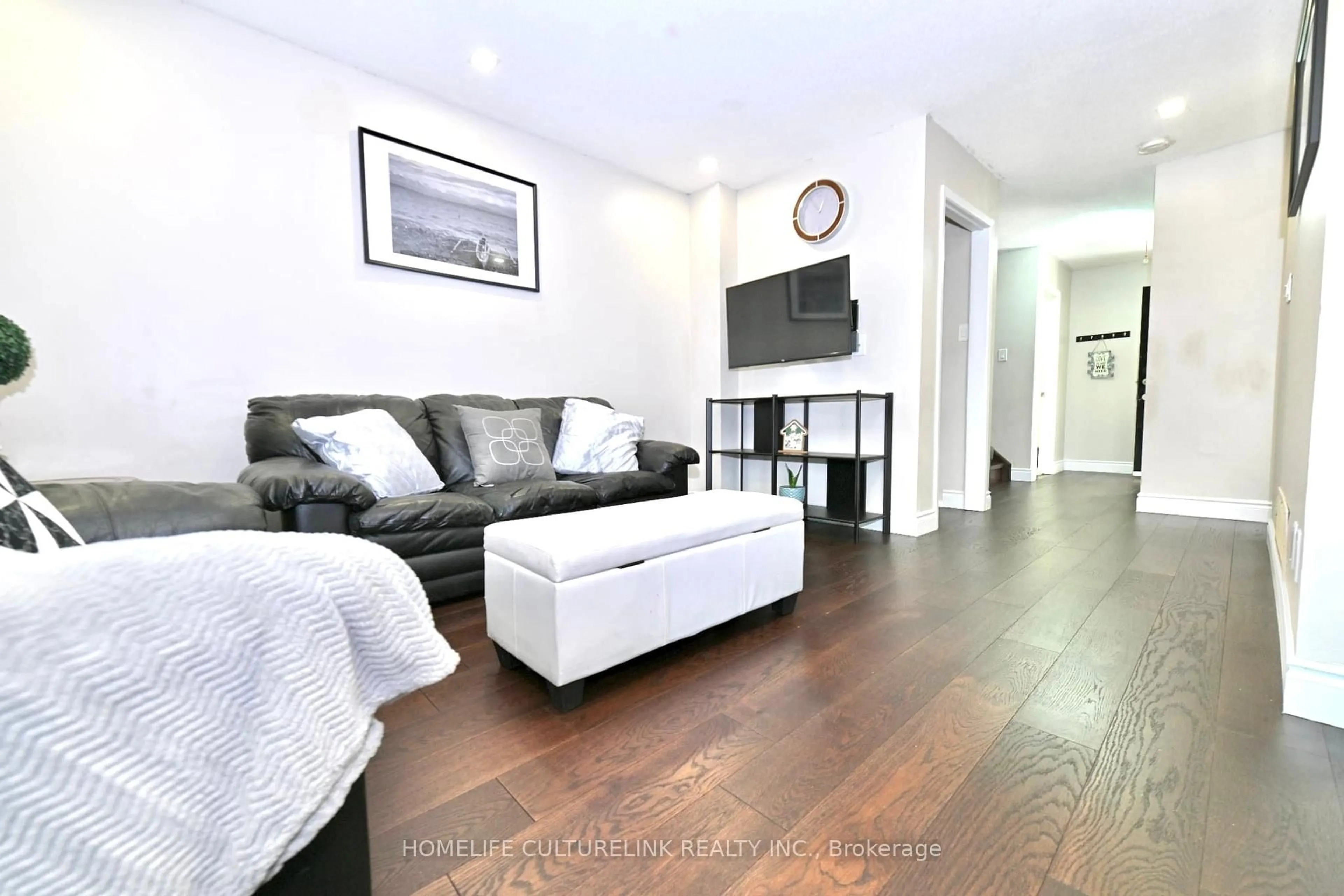 Living room with furniture, wood/laminate floor for 119 Briarwood Ave, Toronto Ontario M9W 6C9