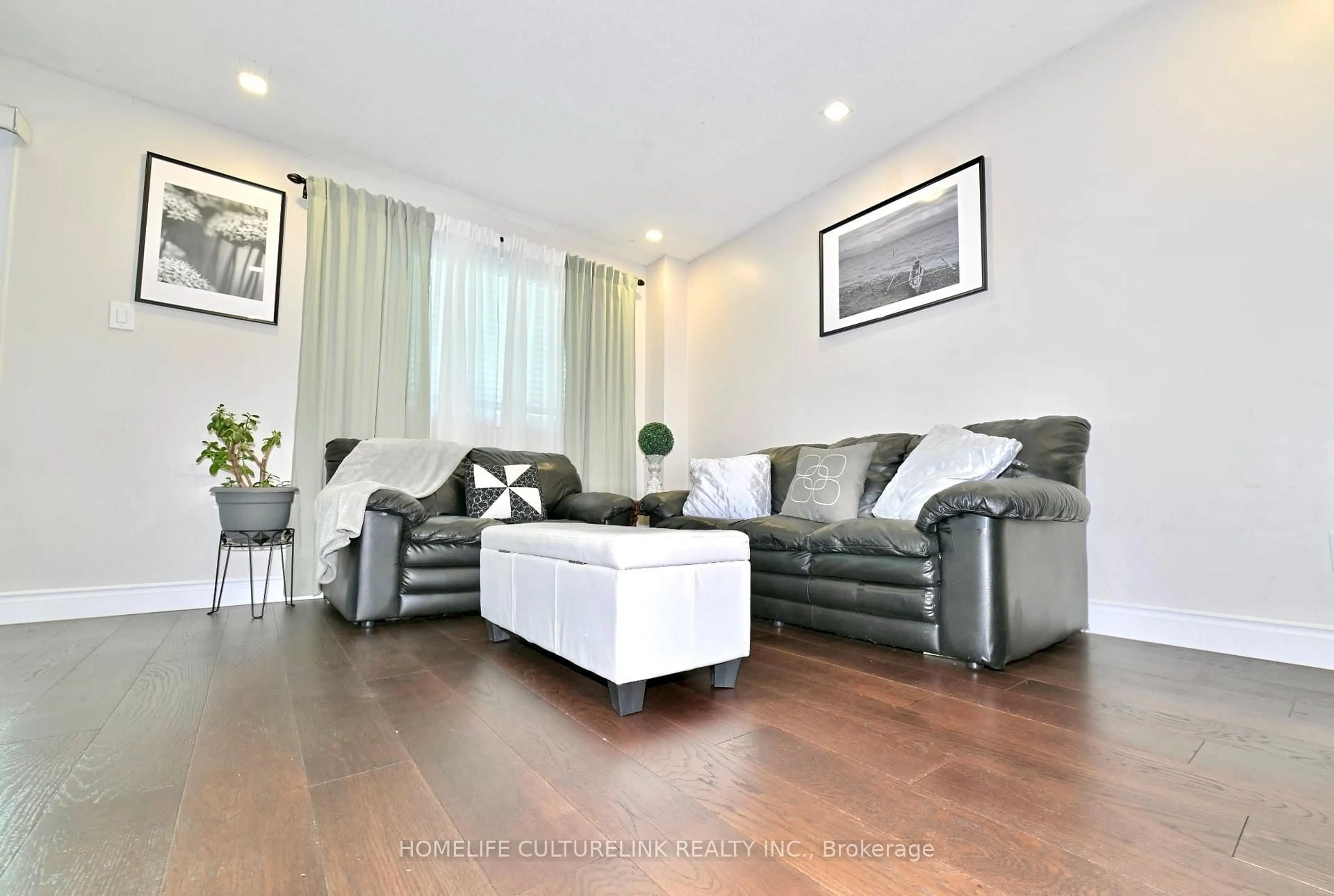 Living room with furniture, wood/laminate floor for 119 Briarwood Ave, Toronto Ontario M9W 6C9