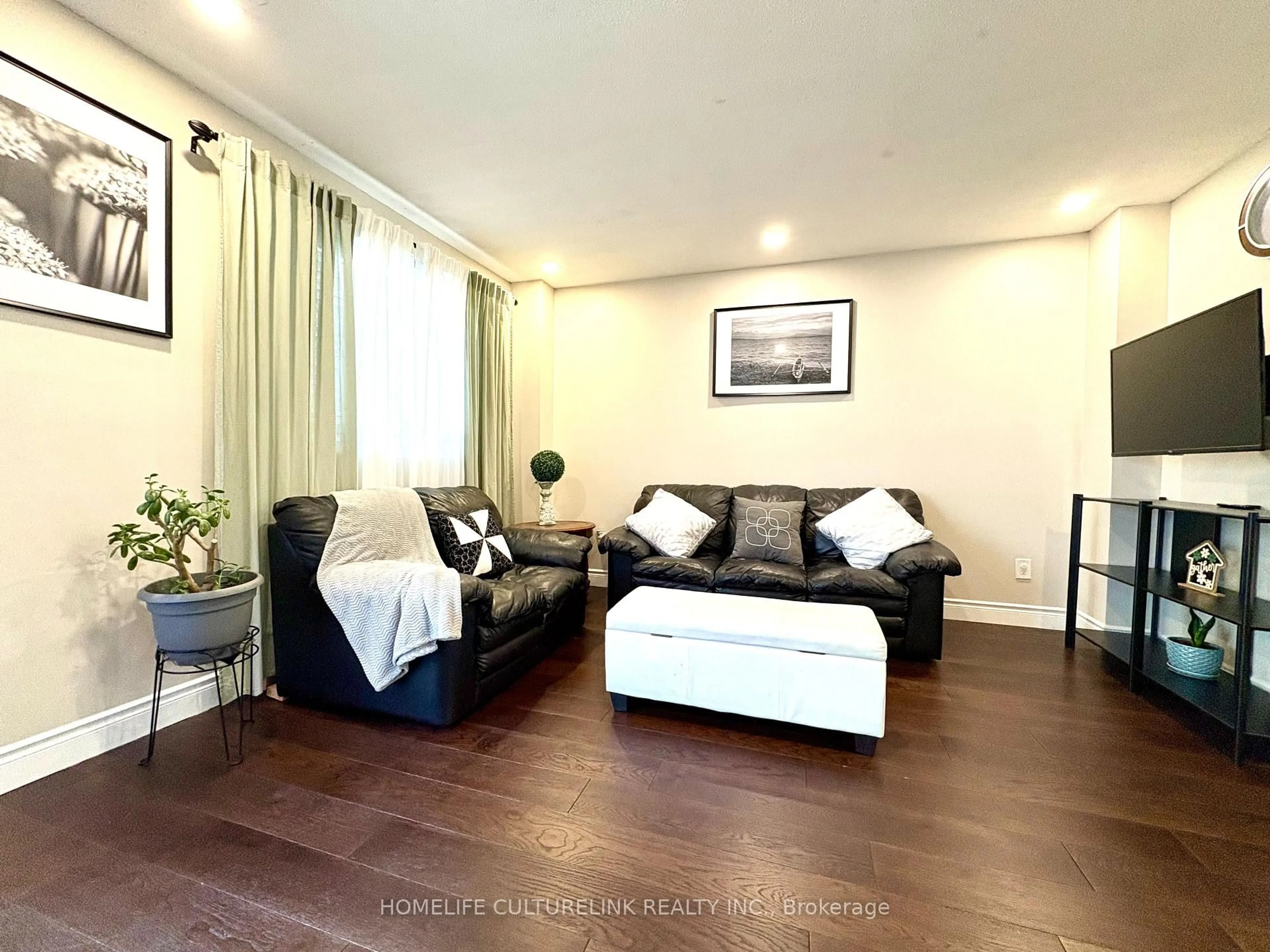 Living room with furniture, wood/laminate floor for 119 Briarwood Ave, Toronto Ontario M9W 6C9