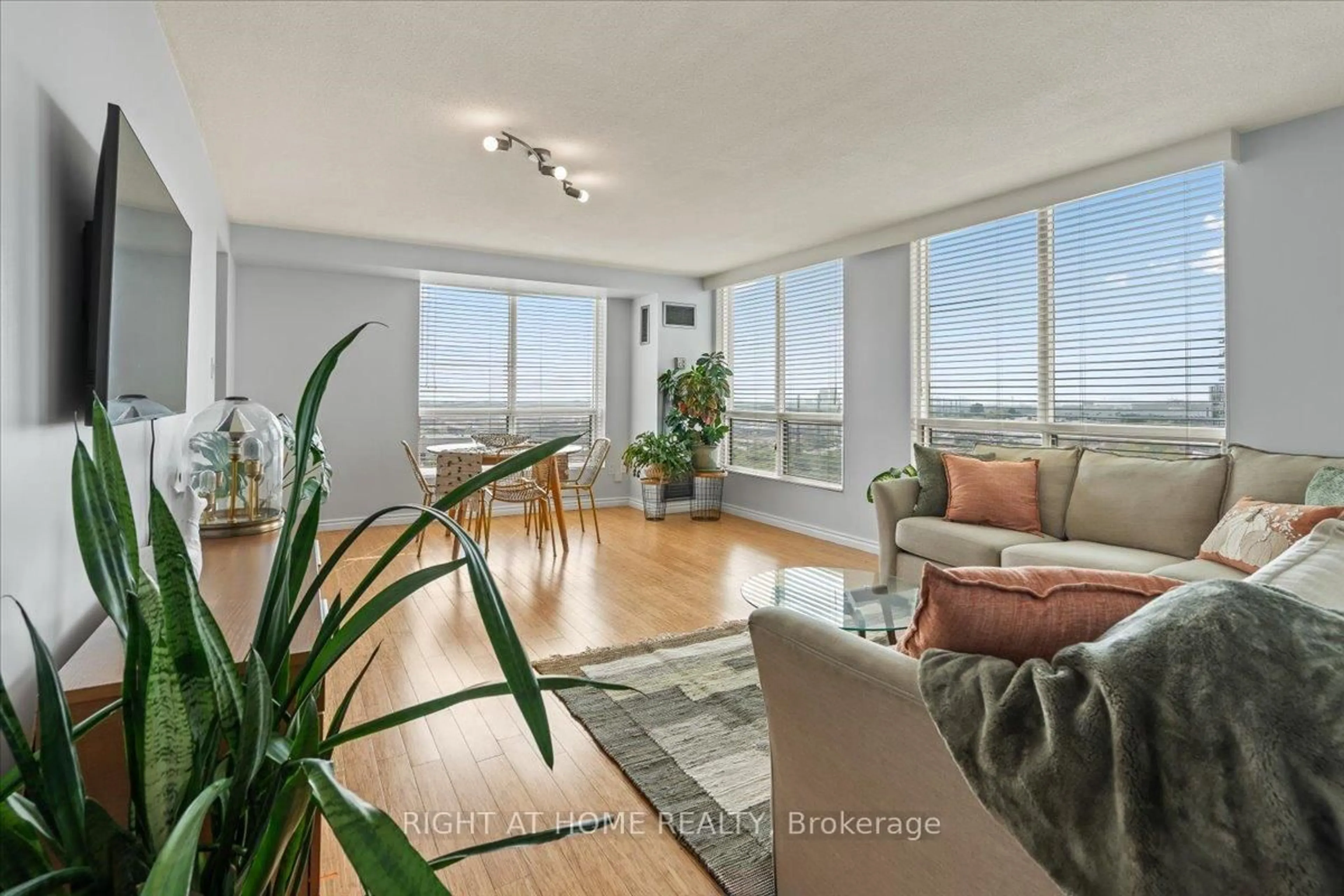 Living room with furniture, wood/laminate floor for 101 Subway Cres #1011, Toronto Ontario M9B 6K4