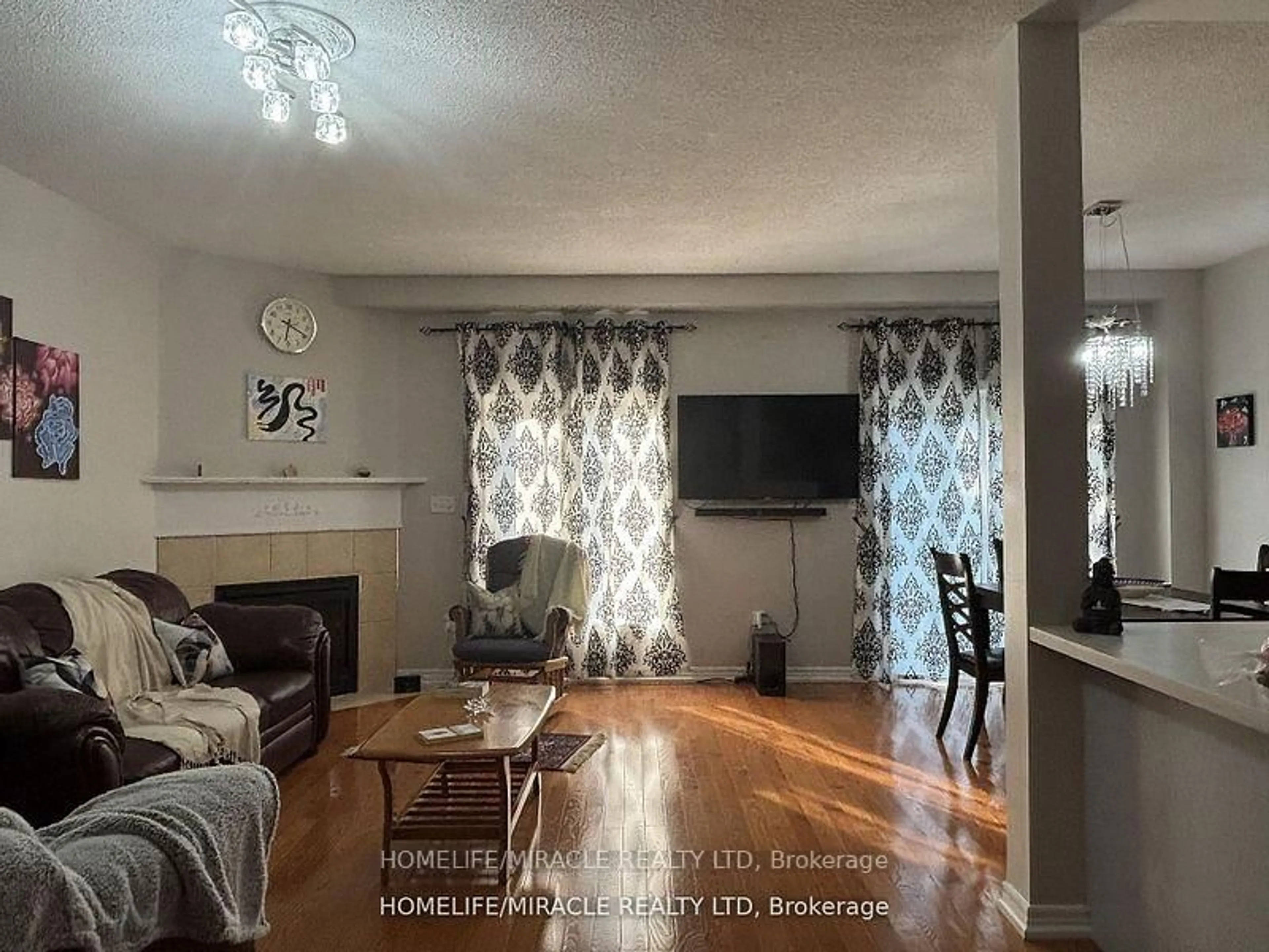 Living room with furniture, wood/laminate floor for 7385 Magistrate Terr #17, Mississauga Ontario L5W 1W8