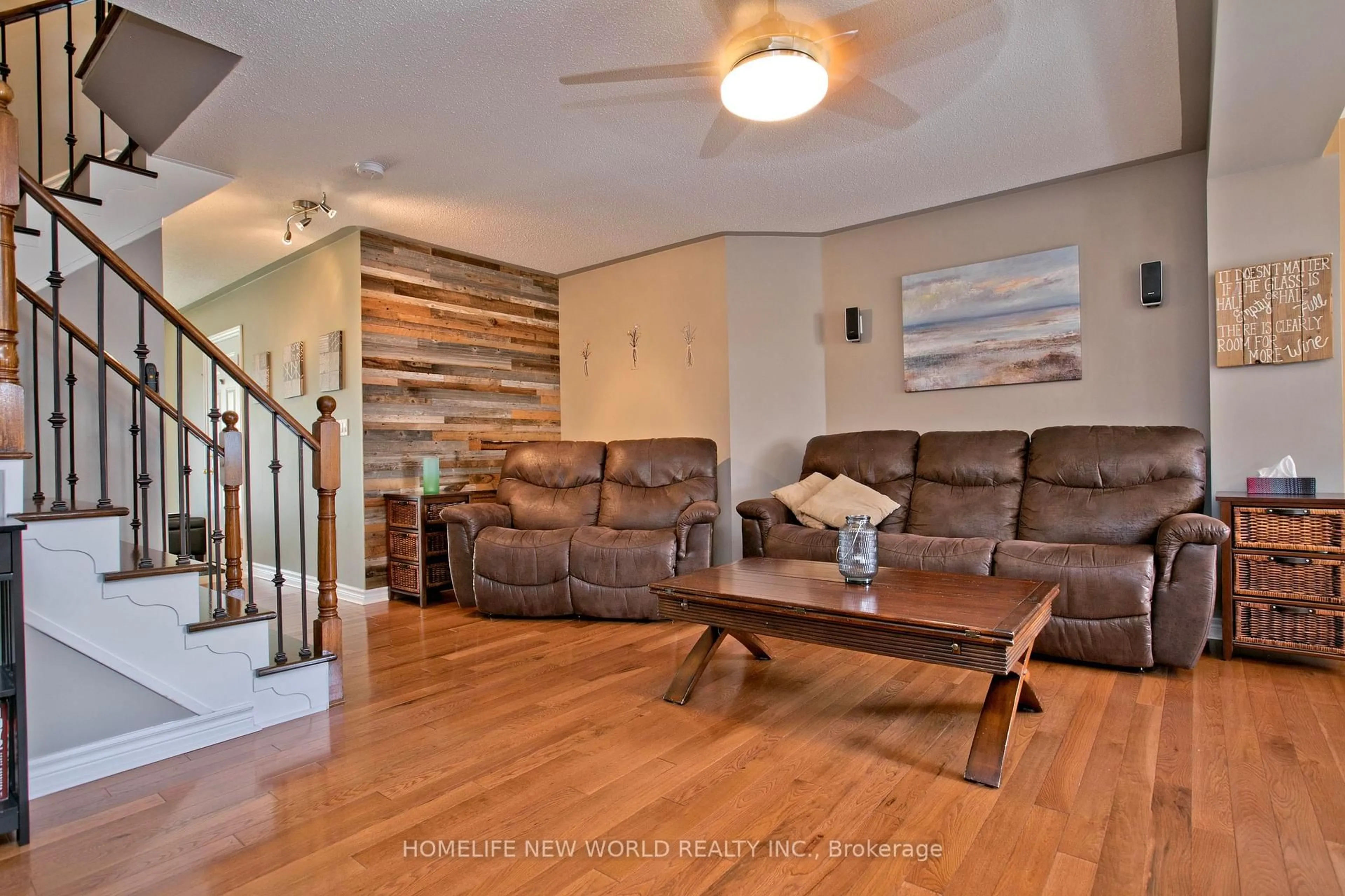 Living room with furniture, wood/laminate floor for 54 Brussels Ave, Brampton Ontario L6Z 0A5