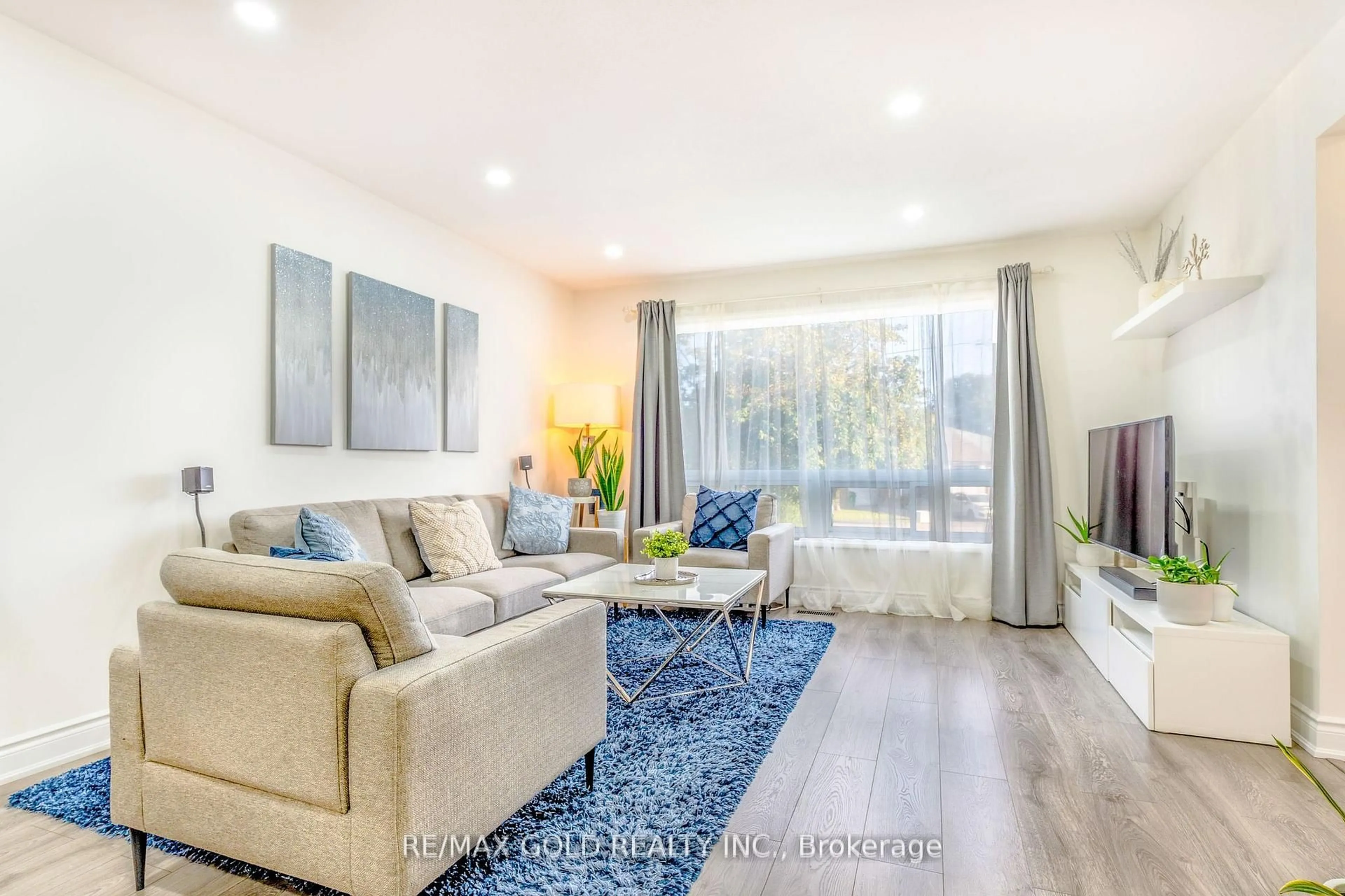 Living room with furniture, wood/laminate floor for 36 Garfield Cres, Brampton Ontario L6V 1V8