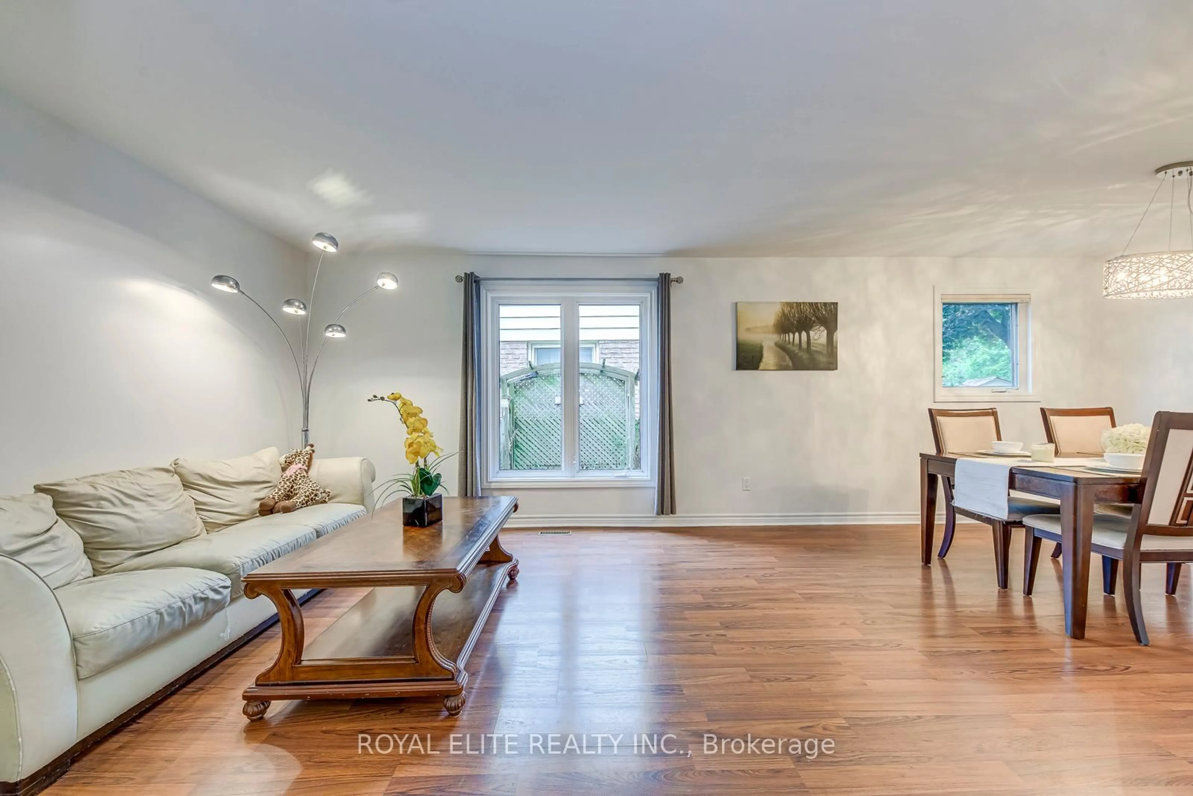 Living room with furniture, wood/laminate floor for 6951 Harris Rd, Mississauga Ontario L5N 4Y9