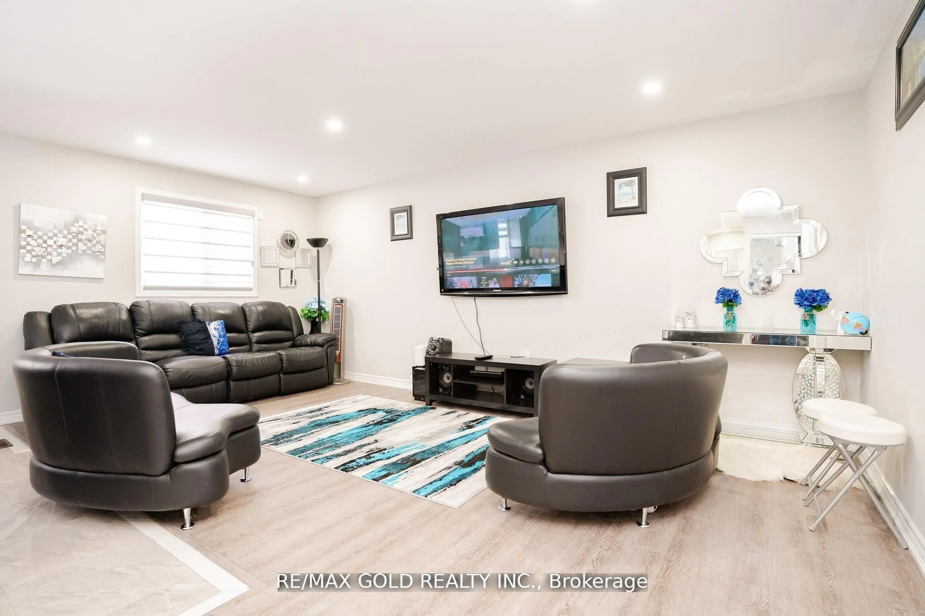 Living room with furniture, wood/laminate floor for 65 Abell Dr, Brampton Ontario L6V 2W1