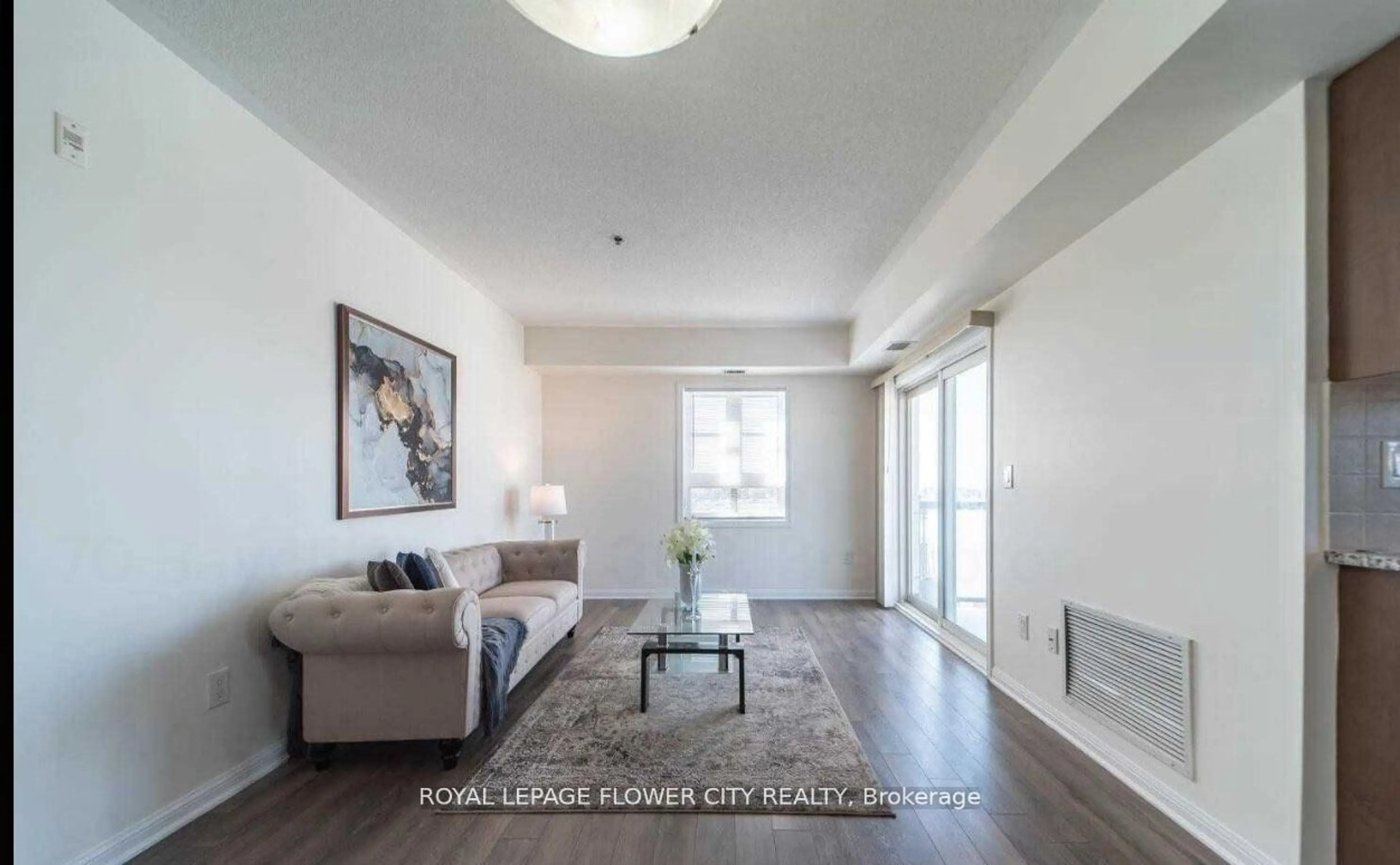 Living room with furniture, wood/laminate floor for 70 Baycliffe Cres #303, Brampton Ontario L7A 0Z5
