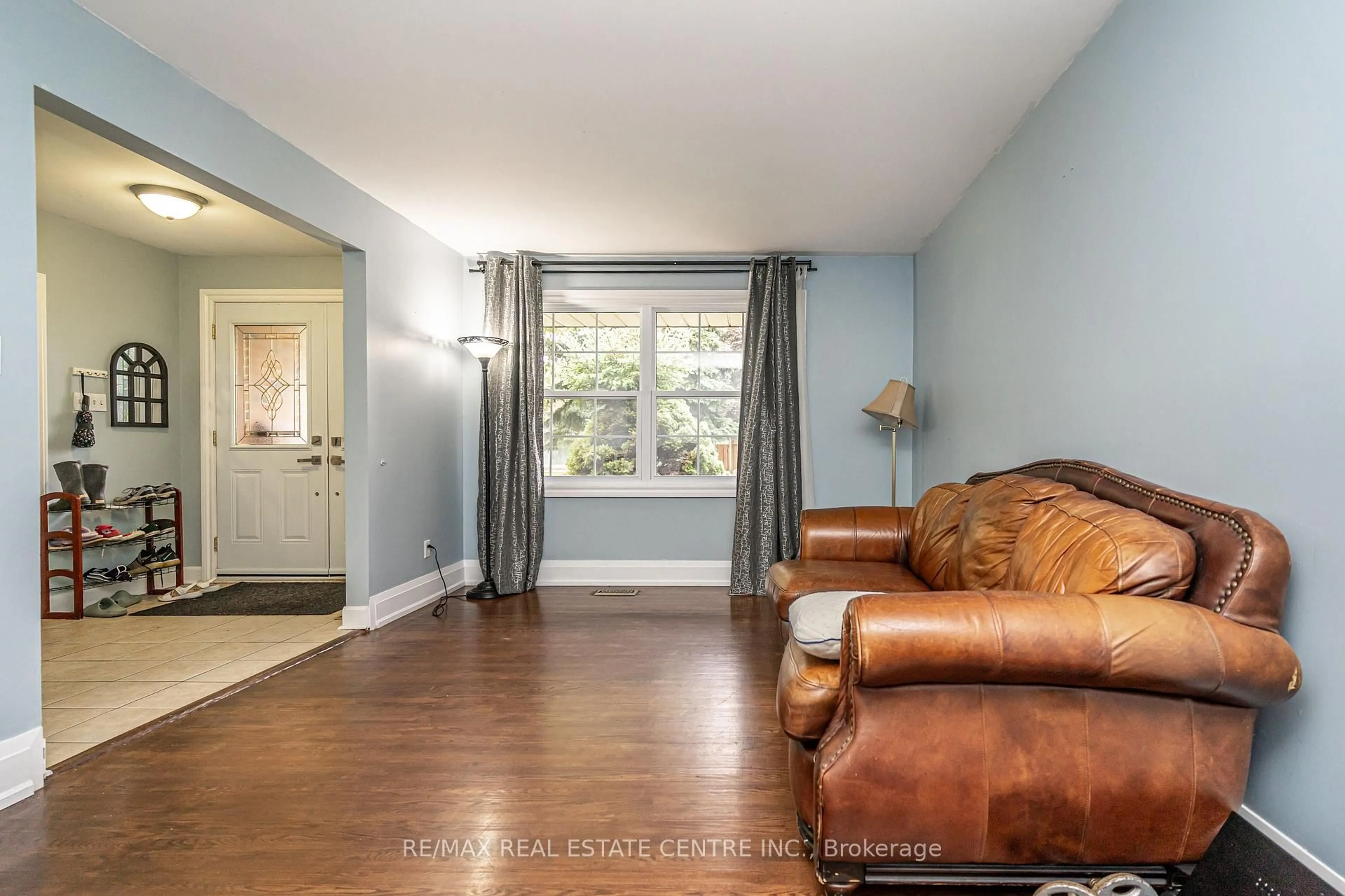 Living room with furniture, wood/laminate floor for 84 Crawley Dr, Brampton Ontario L6T 2S4