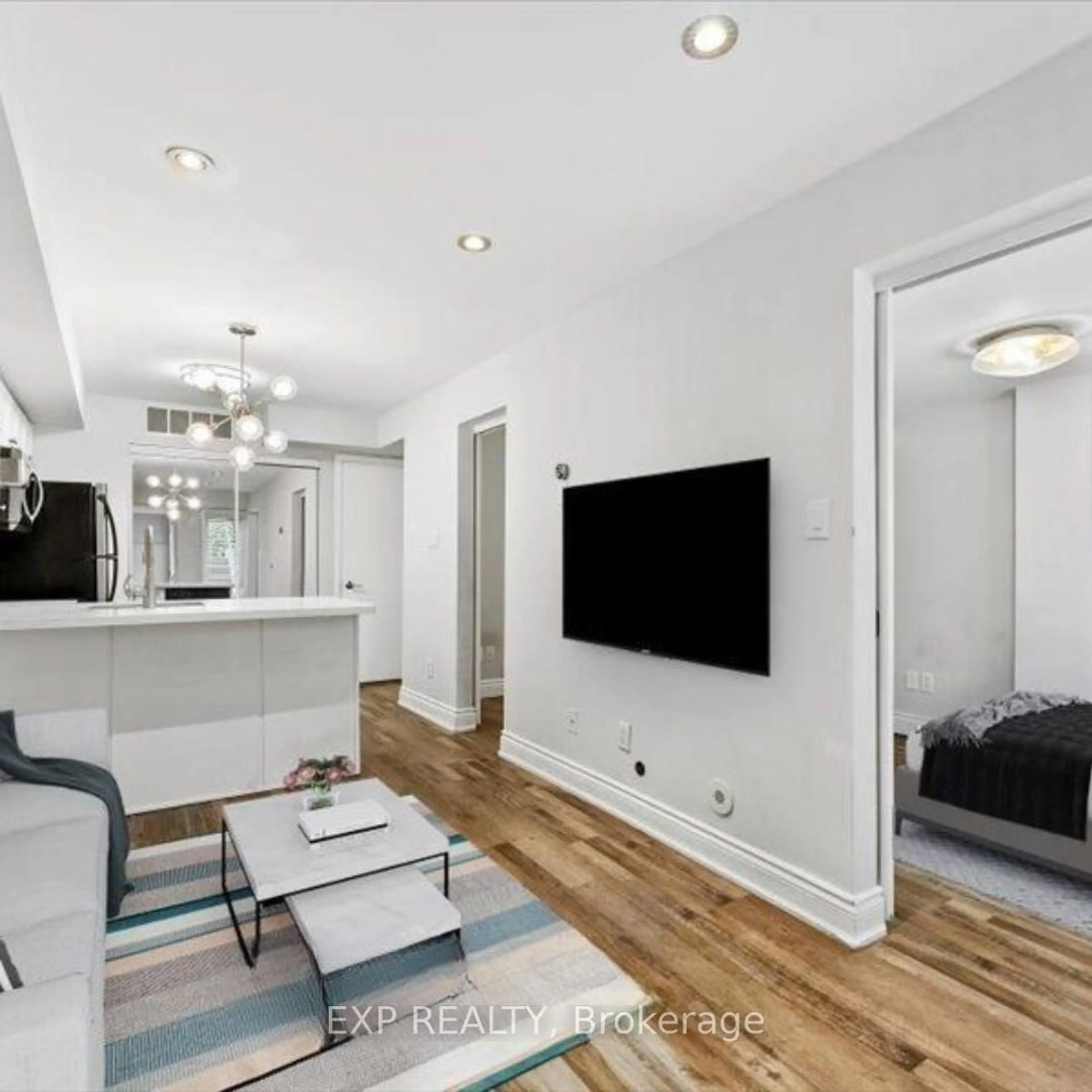 Living room with furniture, wood/laminate floor for 10 Laidlaw St #Th725, Toronto Ontario M6K 1X2