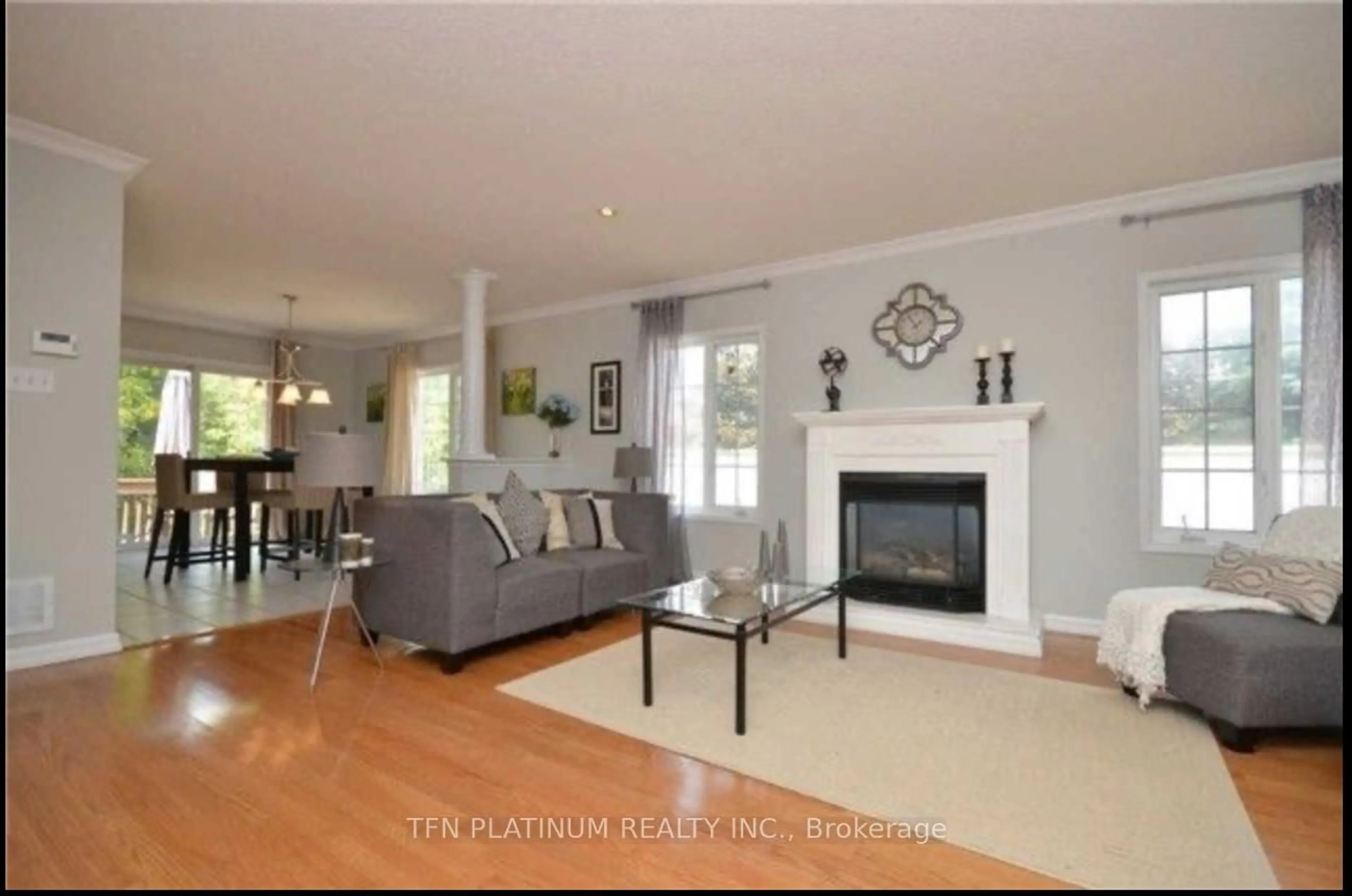 Living room with furniture, wood/laminate floor for 42 Southbend Dr, Brampton Ontario L7A 1K5