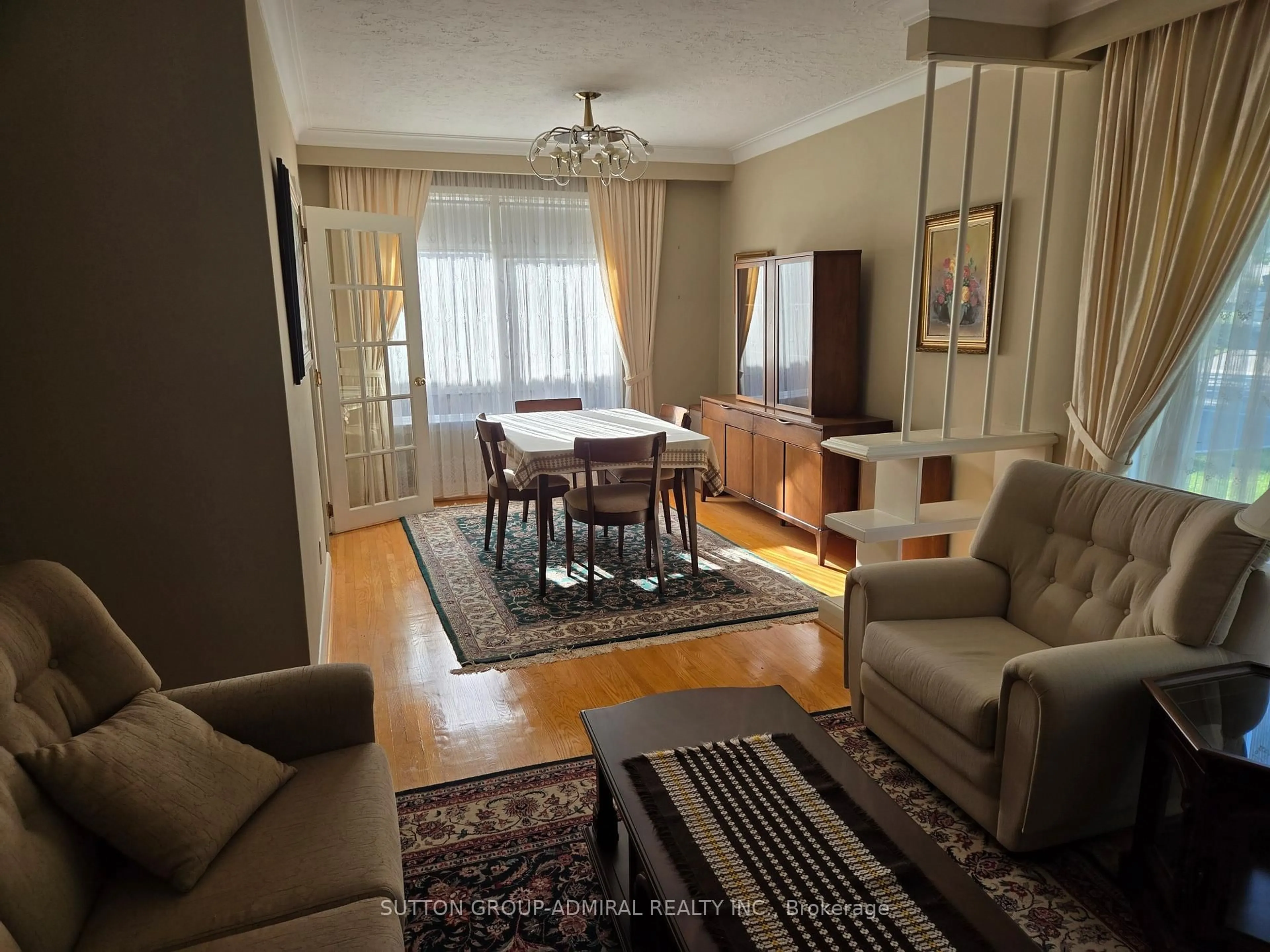 Living room with furniture, wood/laminate floor for 261 Epsom Downs Dr, Toronto Ontario M3M 1T3