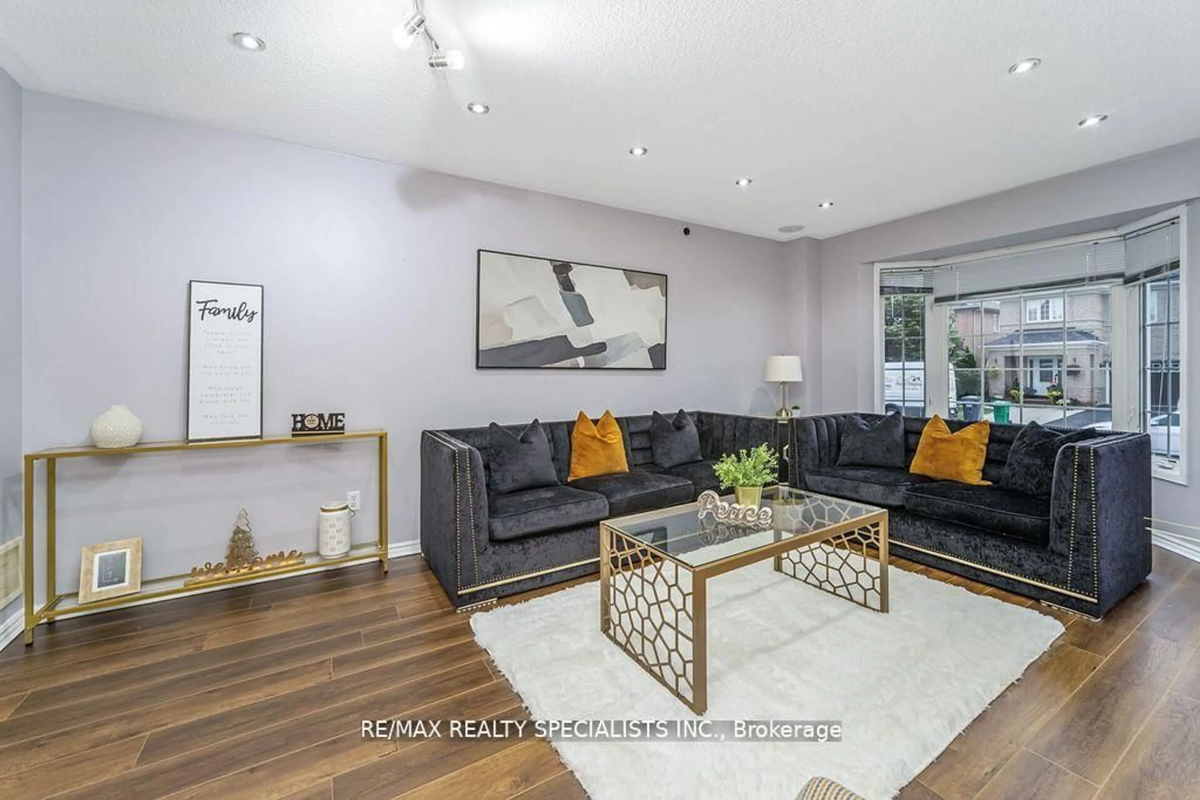 Living room with furniture, wood/laminate floor for 64 Botavia Downs Dr, Brampton Ontario L7A 3N8