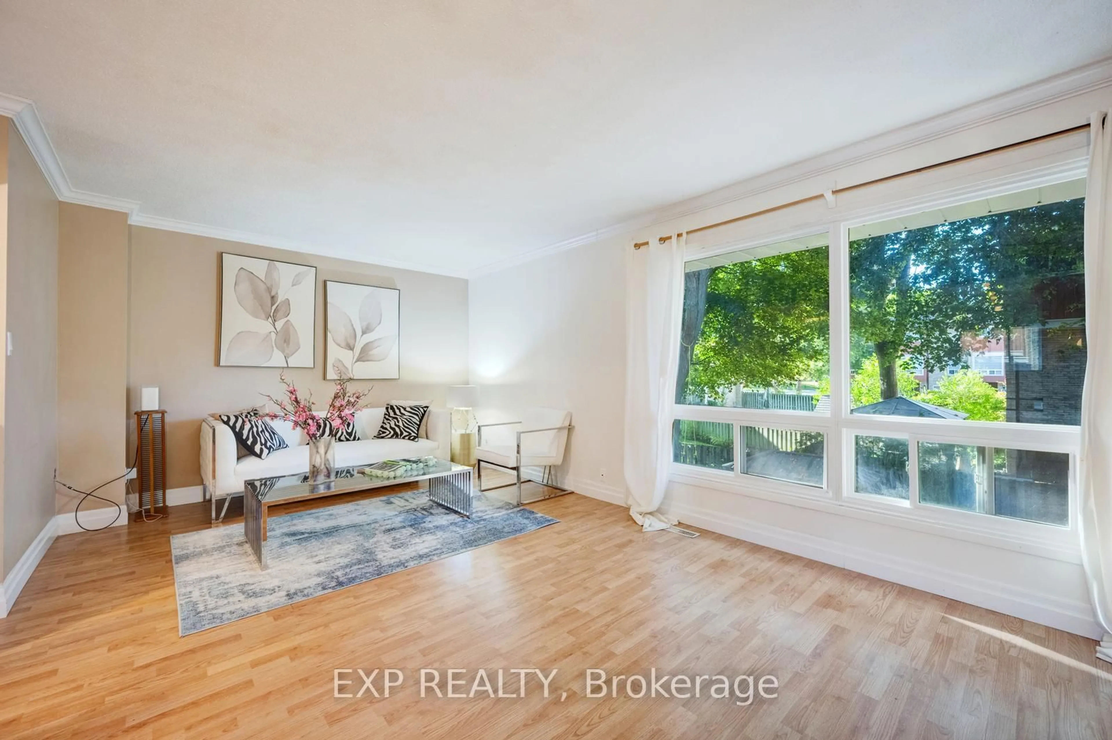 Living room with furniture, wood/laminate floor for 915 Inverhouse Dr, Mississauga Ontario L5J 4B2