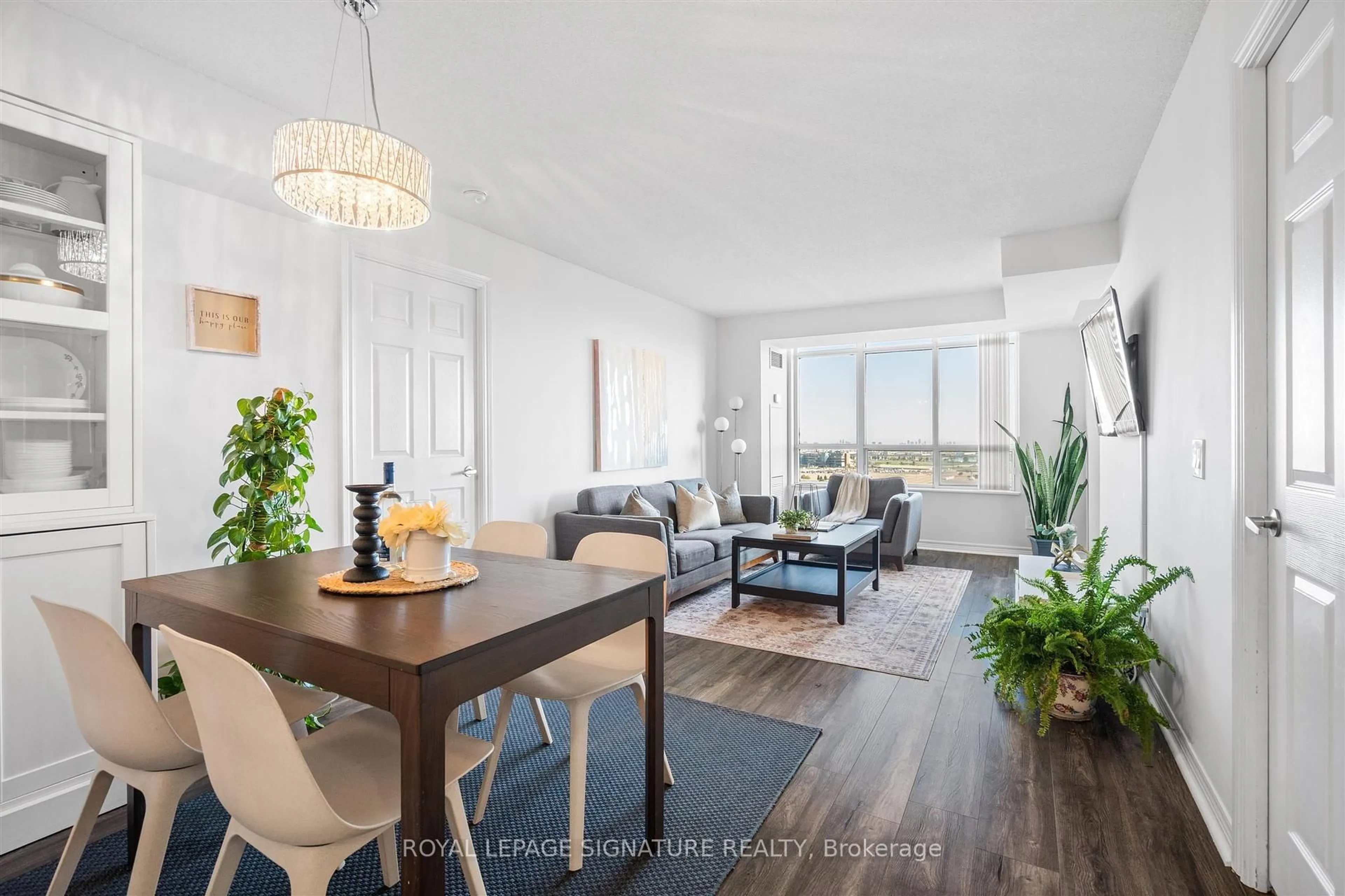 Living room with furniture, wood/laminate floor for 710 Humberwood Blvd #2407, Toronto Ontario M9W 7J5