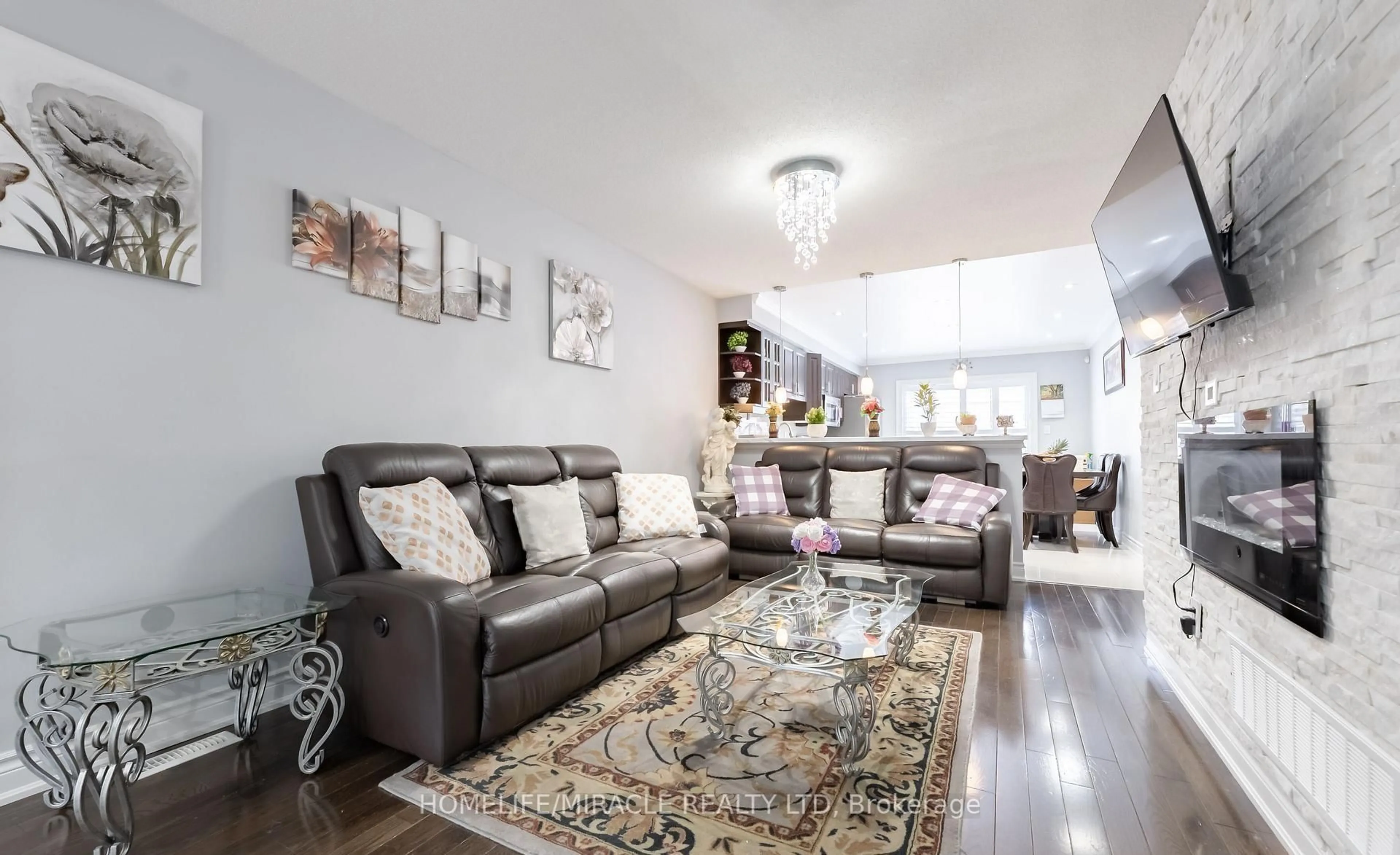 Living room with furniture, wood/laminate floor for 23 Mosley Cres, Brampton Ontario L6Y 5C7