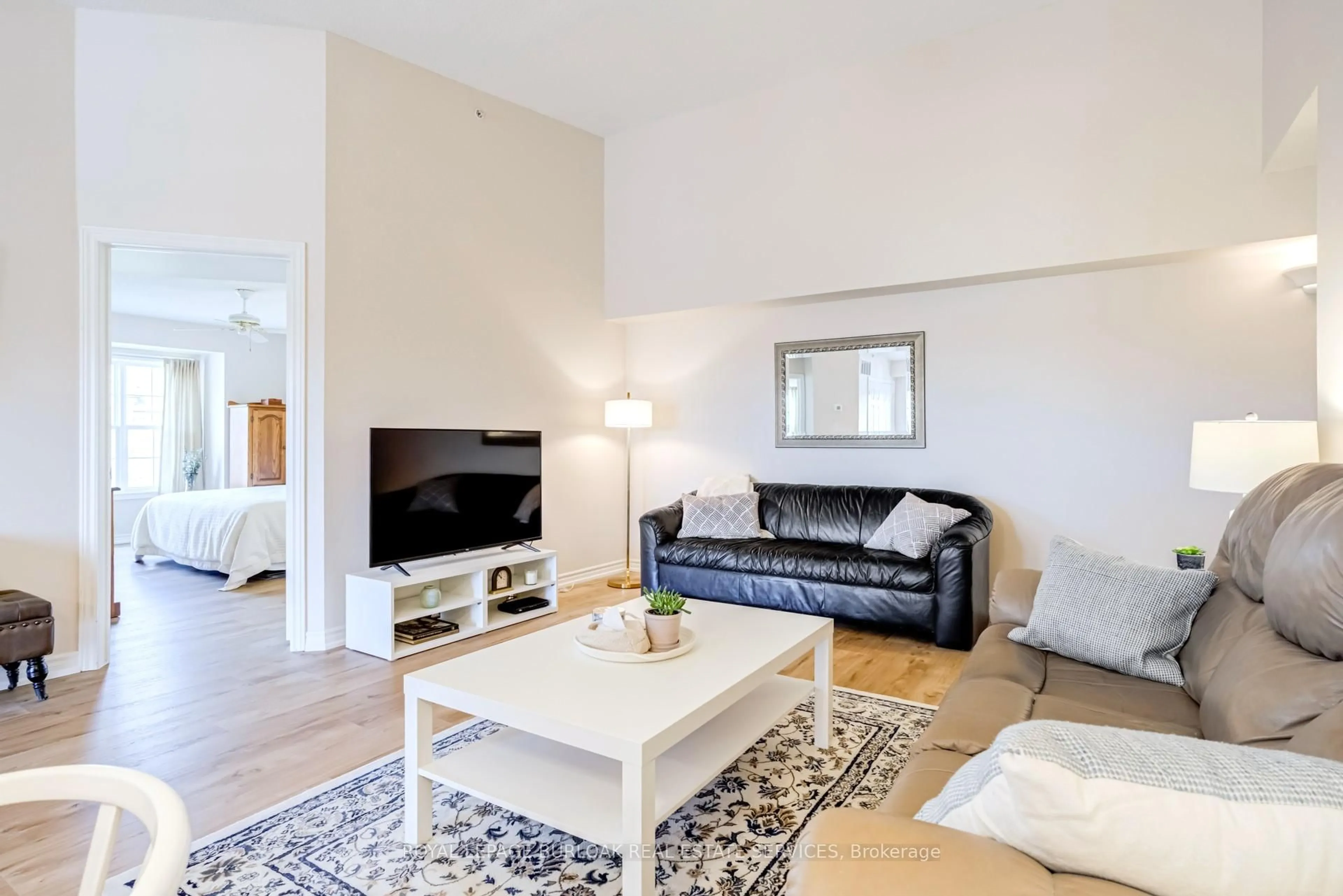 Living room with furniture, wood/laminate floor for 2065 Appleby Line #402, Burlington Ontario L7L 7H2