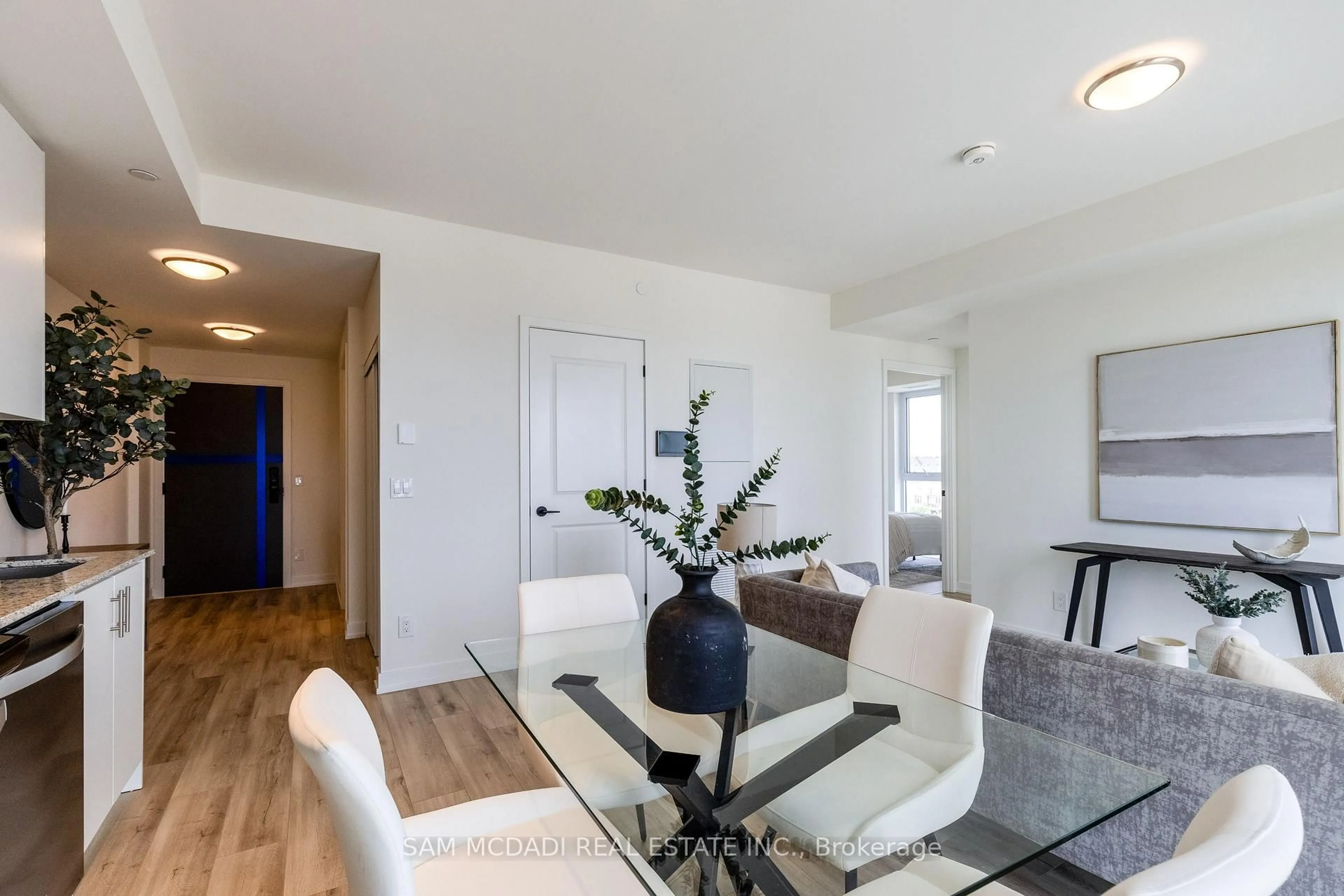 Living room with furniture, wood/laminate floor for 335 Wheat Boom Dr #405, Oakville Ontario L6H 7Y1